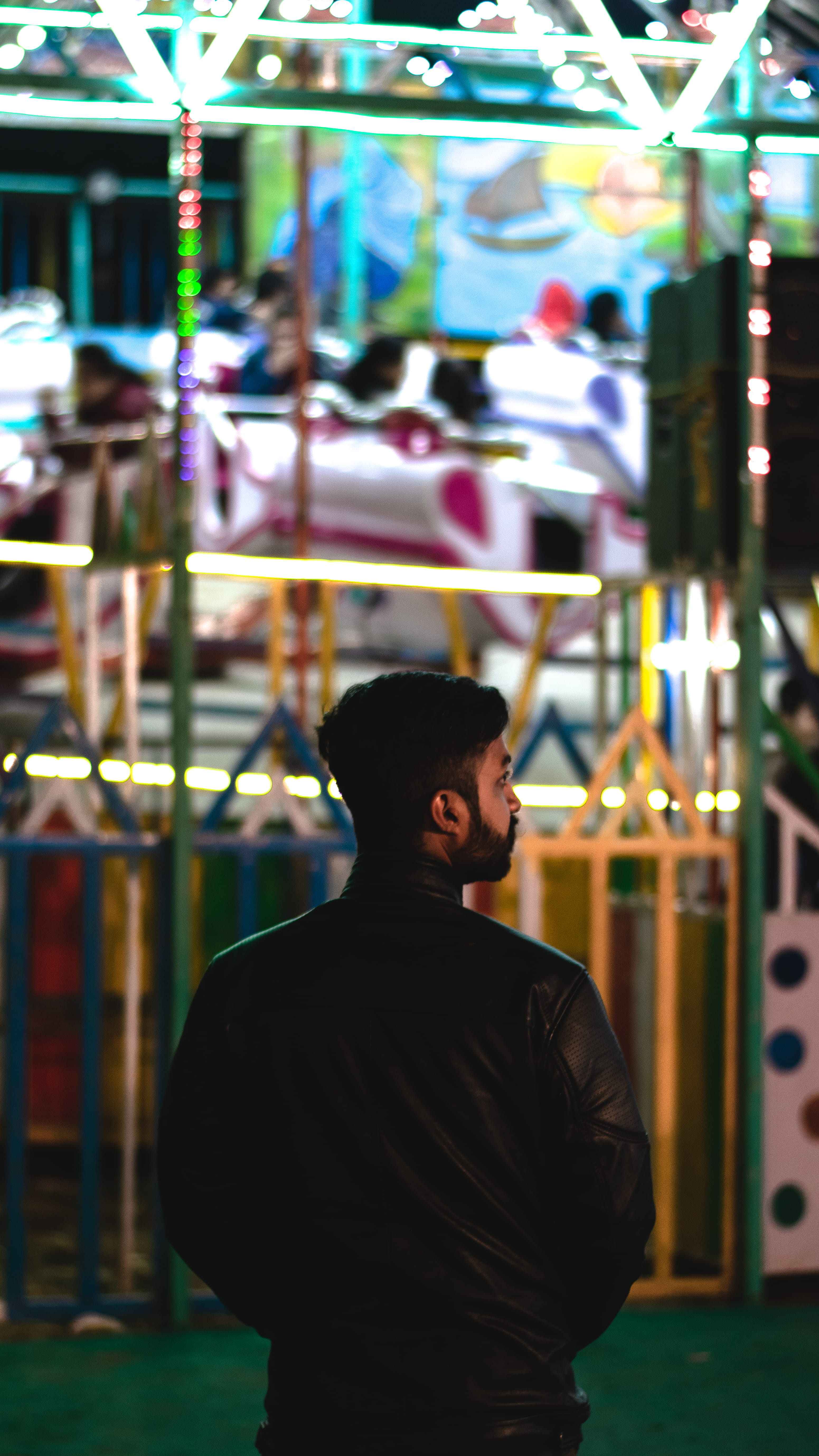 arcade game machine, apparel, person, focus on foreground, man, suit, leisure activity, clothing, night, human, factory, carousel, 5K, casual clothing, Phone HD Wallpaper