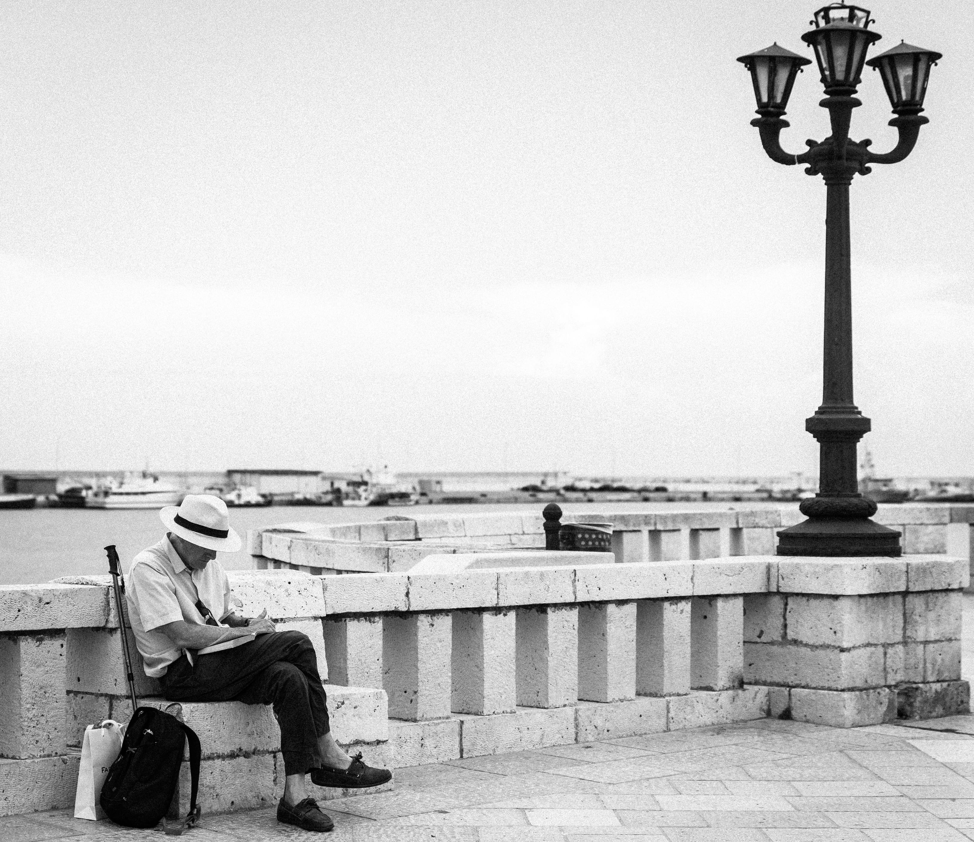 day, seat, street light, lamp post, man, people, nature, men, railing, lighting equipment, copy space, human, shoe, footwear, apparel, gray, black and white, HD Wallpaper