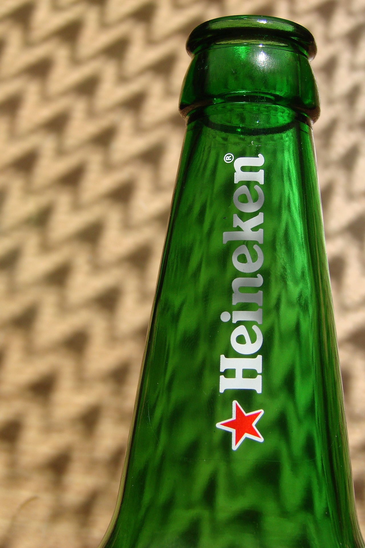 guidance, bottle, sign, container, heineken, glass - material, outdoors, capital letter, shadows, wall - building feature, rays, 1080P, text, high angle view, Phone HD Wallpaper
