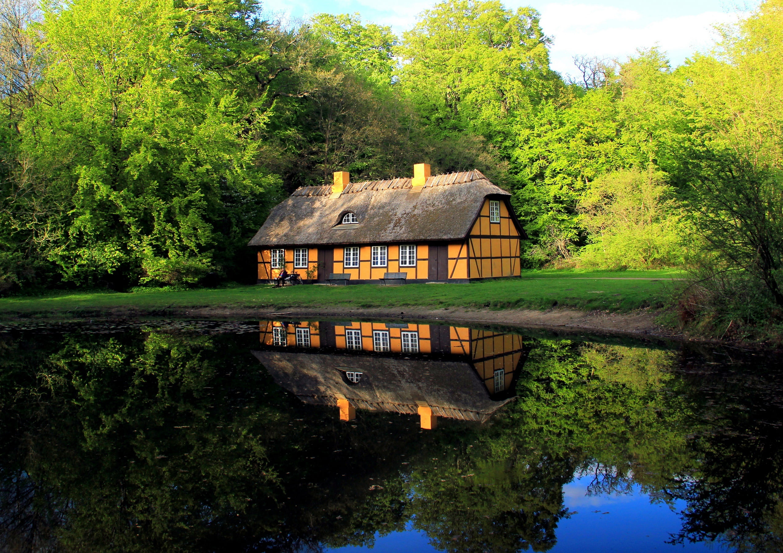 tranquil scene, building exterior, reflection, lake, tree, house, water, near, trees, plant, Denmark, day, built structure, brown, pond, nature, comfort, HD Wallpaper