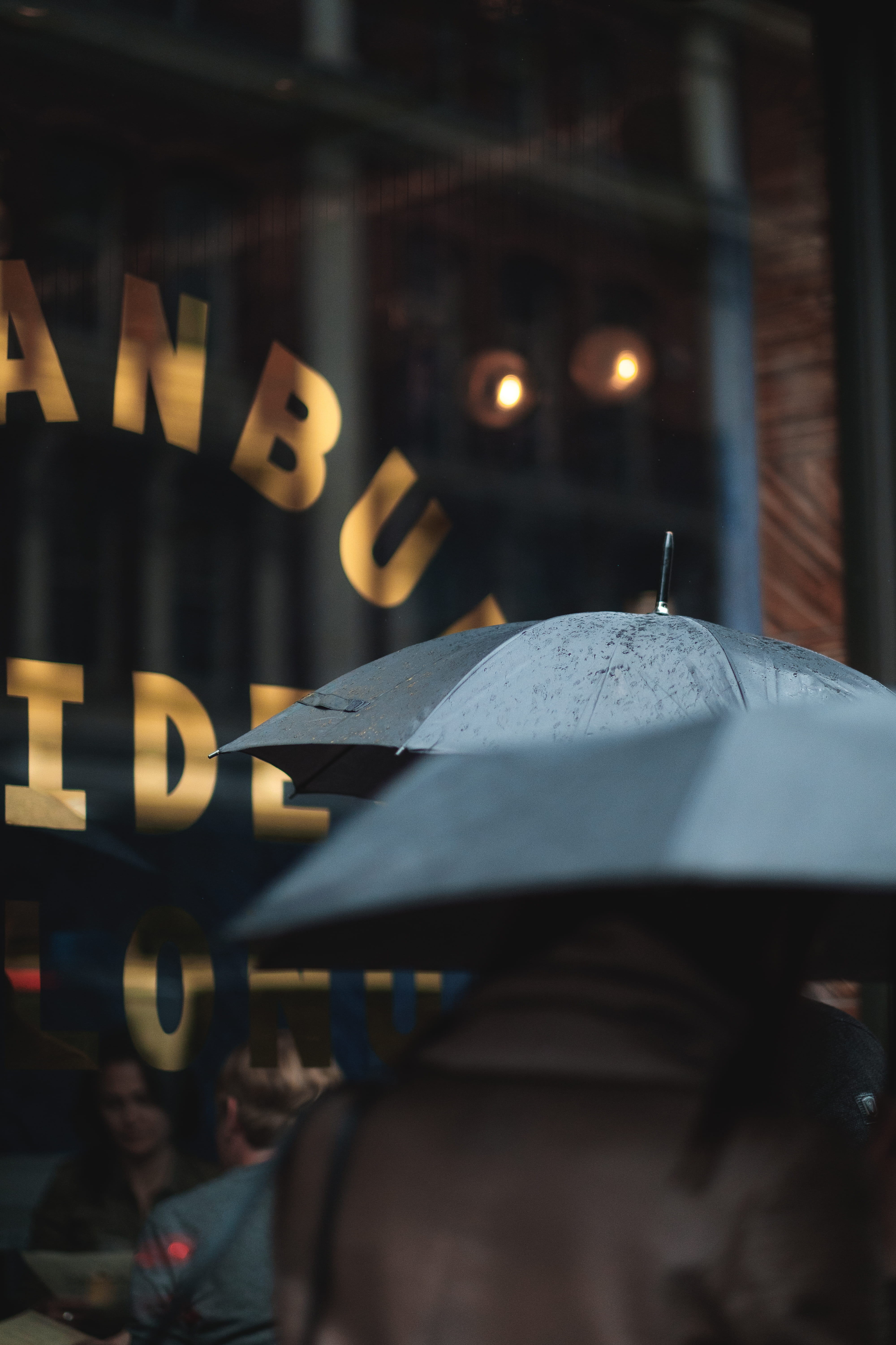 umbrella, transportation, rainy, 5K, outdoors, selective focus, black umbrella, men, person, built structure, jacket, incidental people, mode of transportation, Phone HD Wallpaper