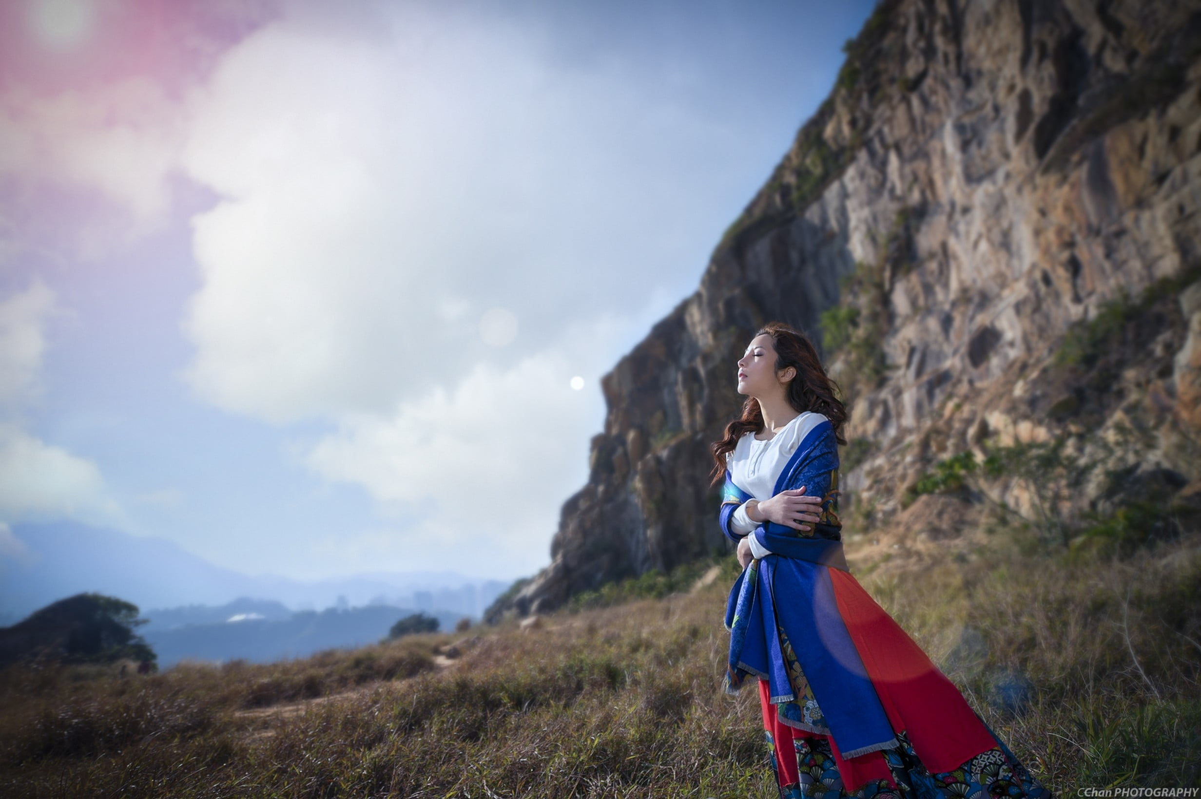 land, rock, cloud - sky, wavy hair, Asian, adult, dress, young adult, sky, brunette, standing, non-urban scene, lifestyles, young women, side view, hands crossed, HD Wallpaper