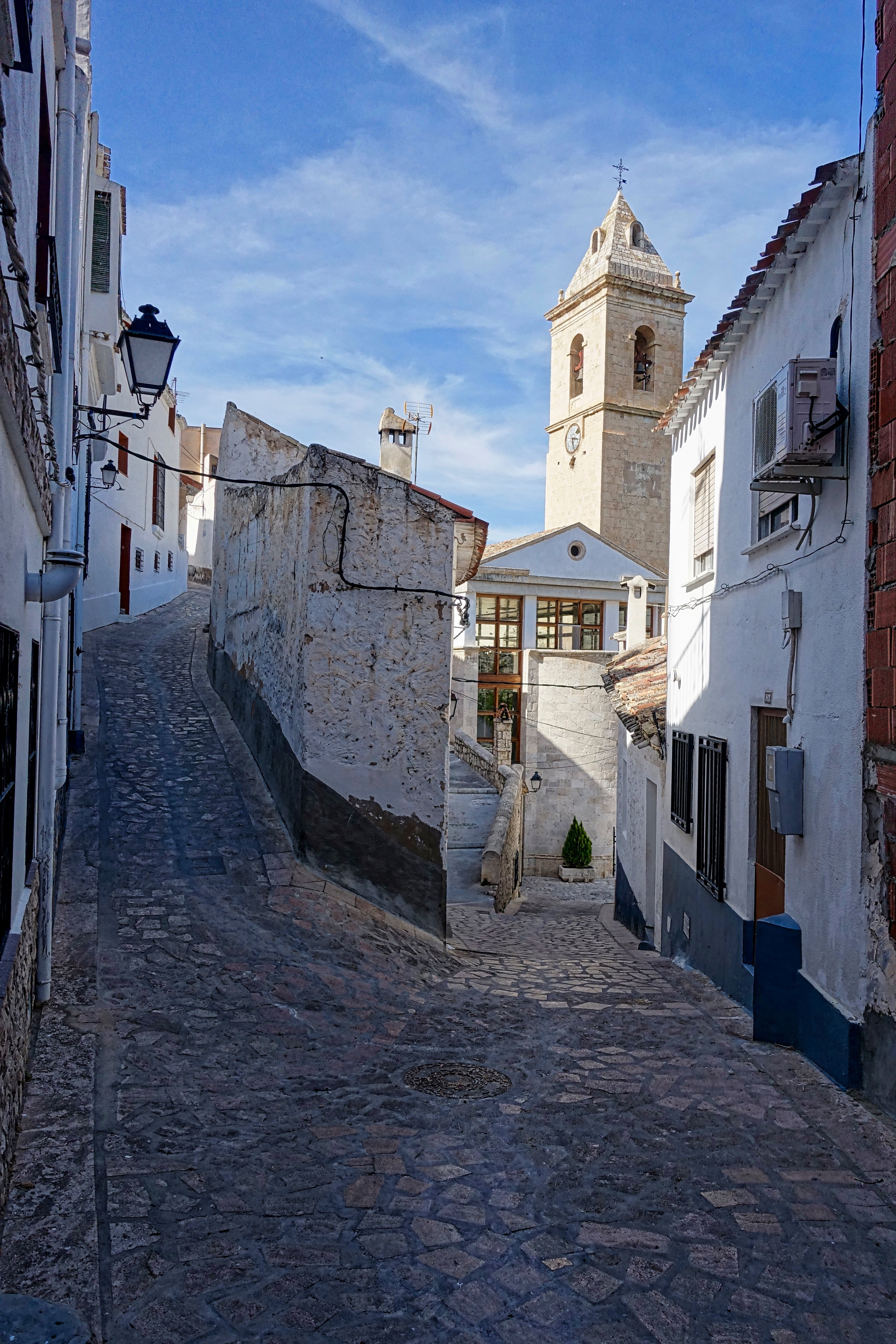 lane, building, architecture, sky, footpath, city, day, the way forward, alcala del jucar, cloud - sky, residential district, religion, cobblestones, town, Phone HD Wallpaper
