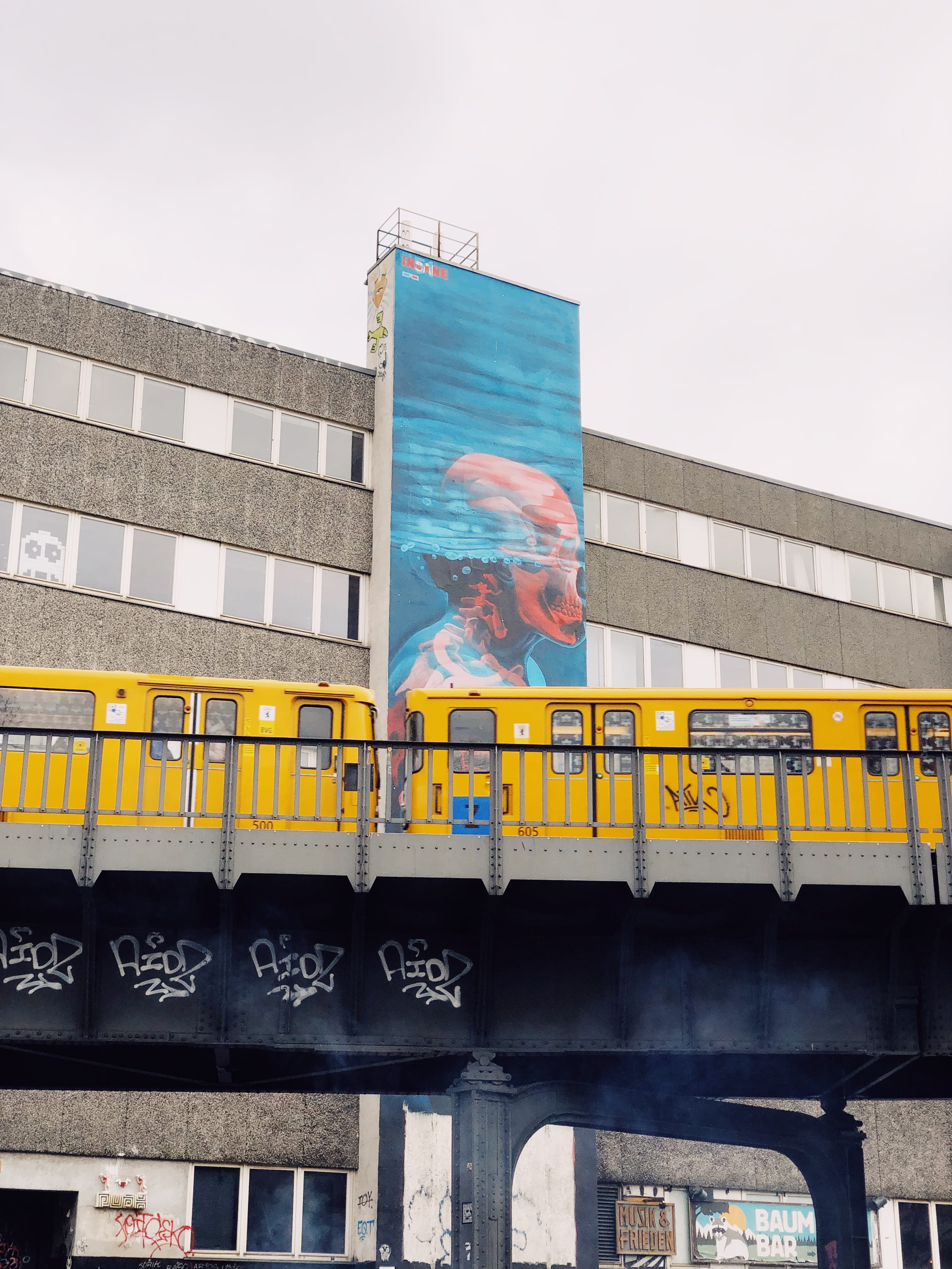 building, nature, text, advertisement, street, train - vehicle, city, oberbaum bridge, outdoors, mode of transportation, germany, daytime, billboard, yellow, Phone HD Wallpaper