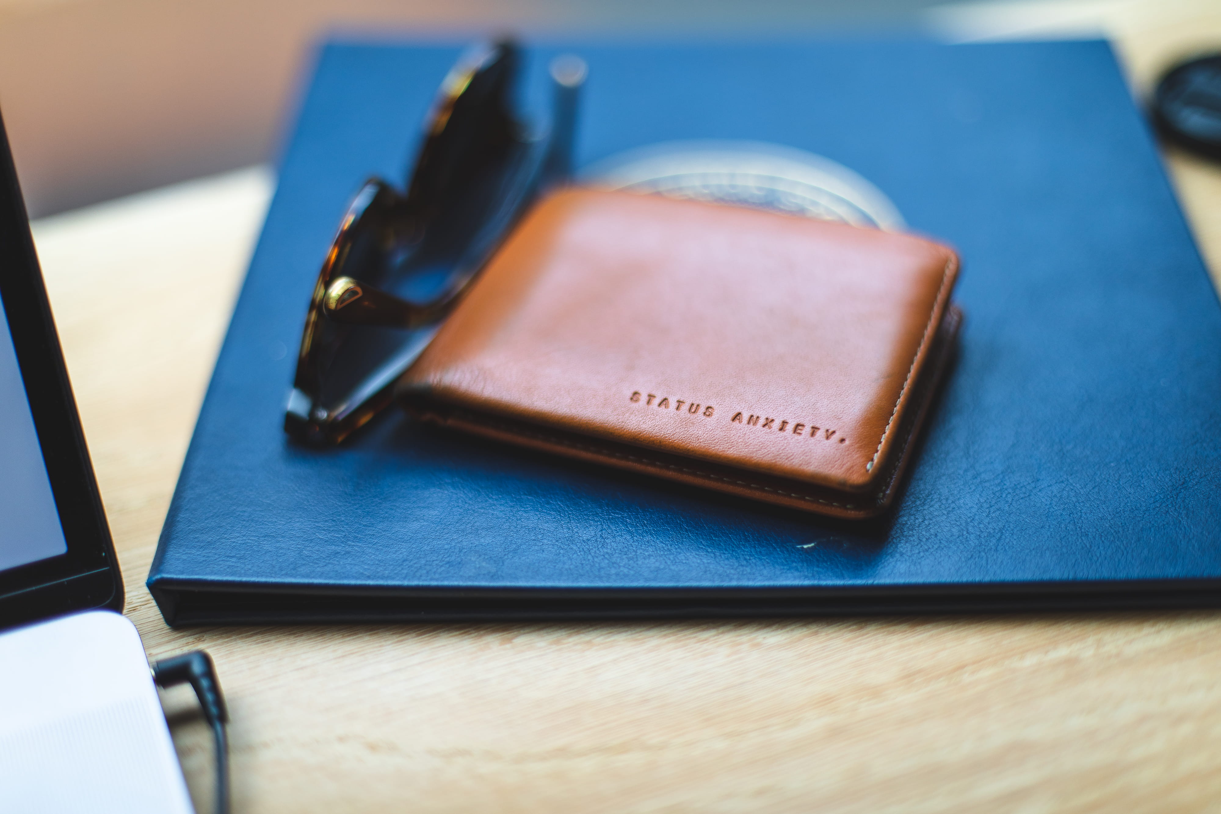 bokeh, wallet, book, bi, blur, mood, still life, small group of objects, note pad, cafe, coffee shop, pen, close-up, text, wood - material, blue, table, HD Wallpaper