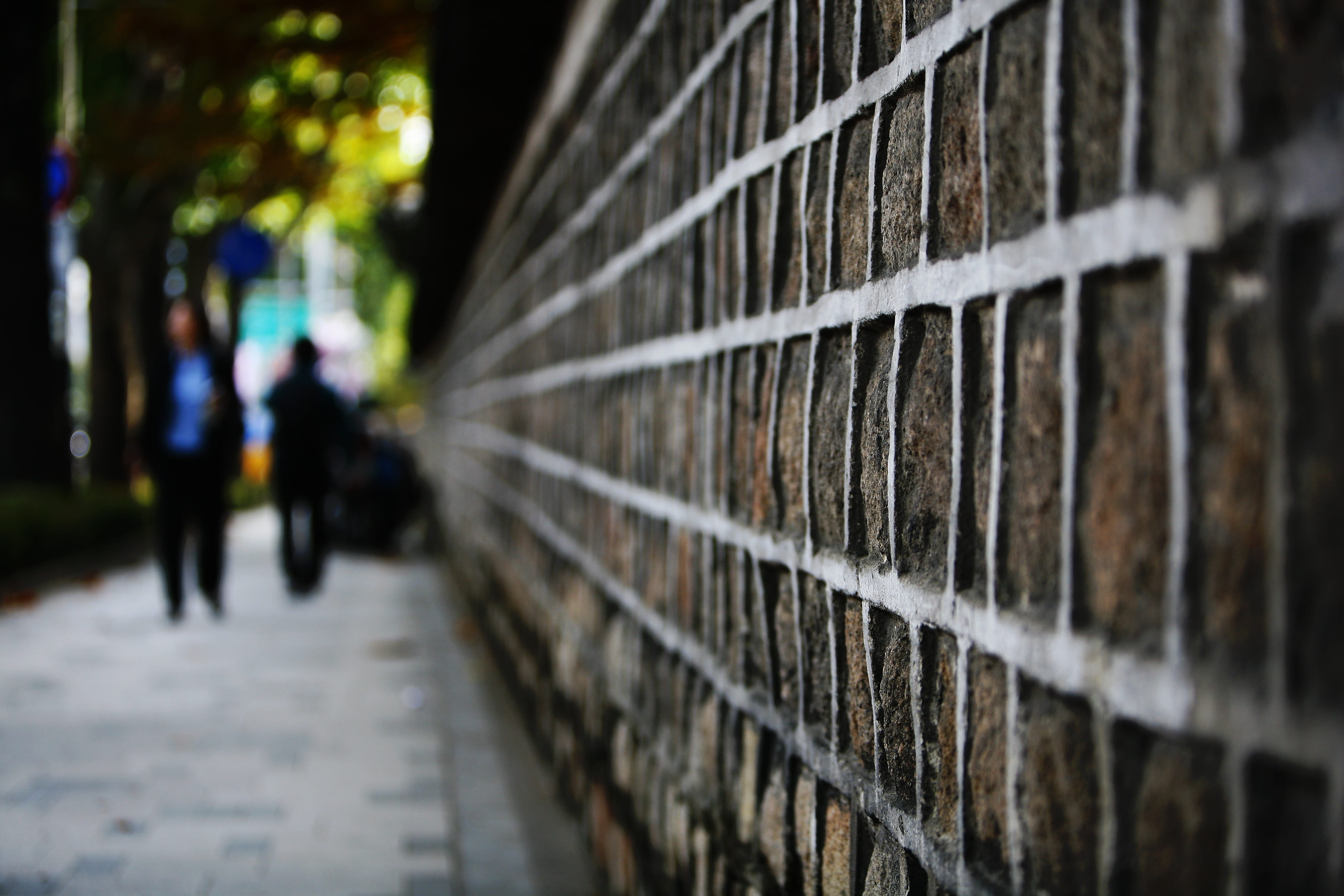 building exterior, city, stone will, walking, people, day, outdoors, selective focus, architecture, lifestyles, wall, direction, 4K, forbidden city, focus on foreground, HD Wallpaper