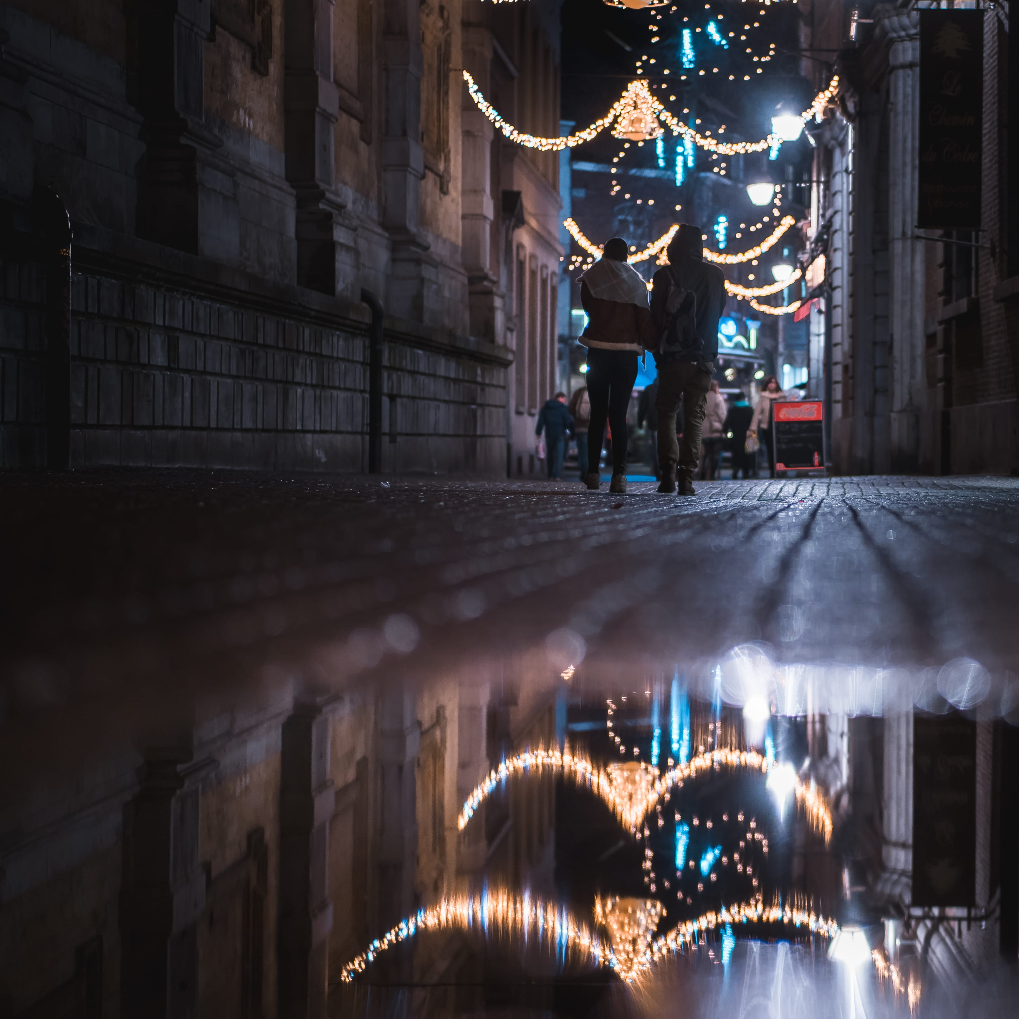 building, evening, illuminated, standing, couple walking, 2K, night, buildings, city, human arm, christmas lights, water, urban, cobblestone street, built structure, Phone HD Wallpaper