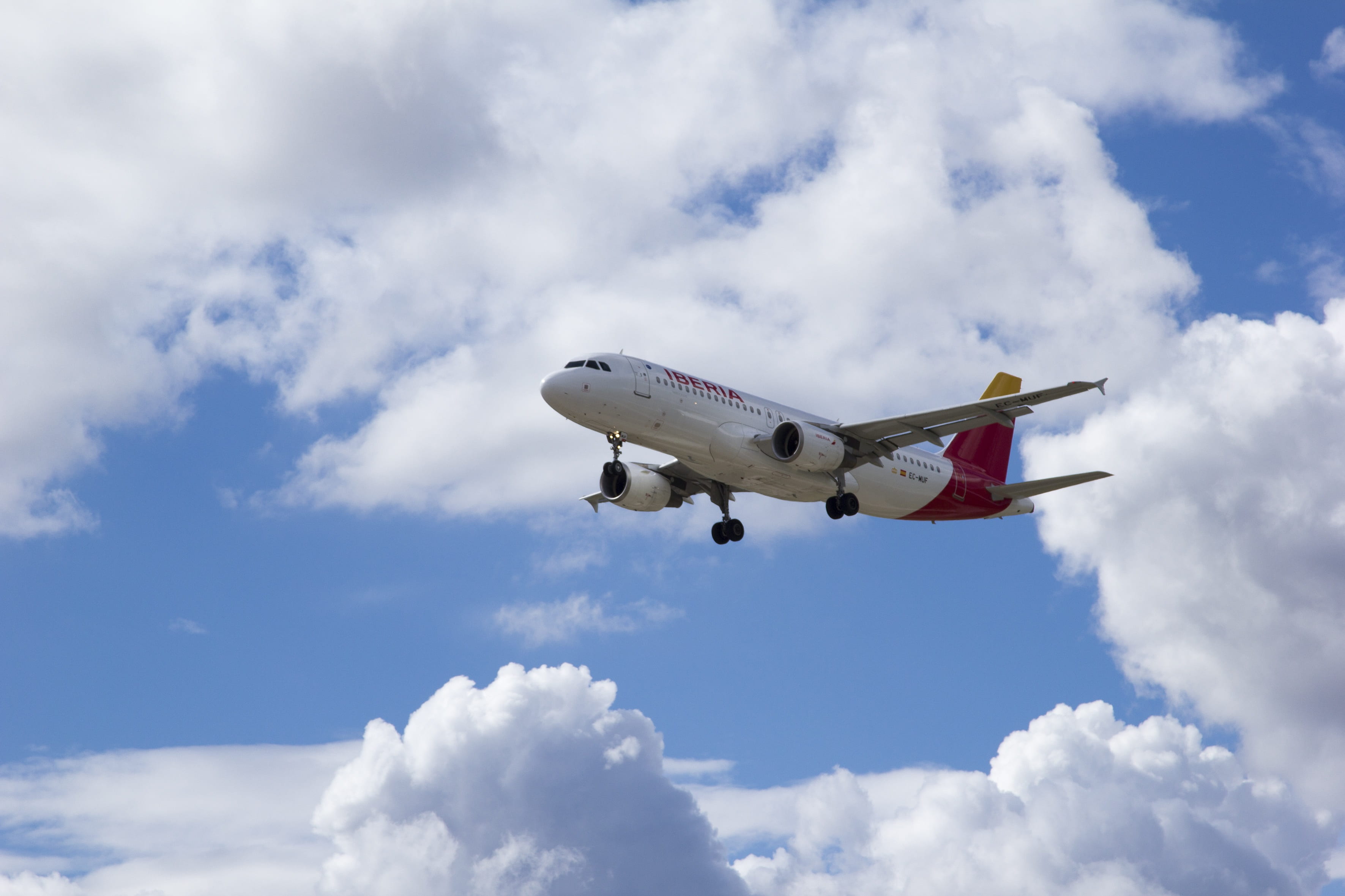mid-air, 2K, transportation, flight, clouds, decks, approximation, sky, arrival, on the move, motion, low angle view, nature, aircraft, mode of transportation, HD Wallpaper