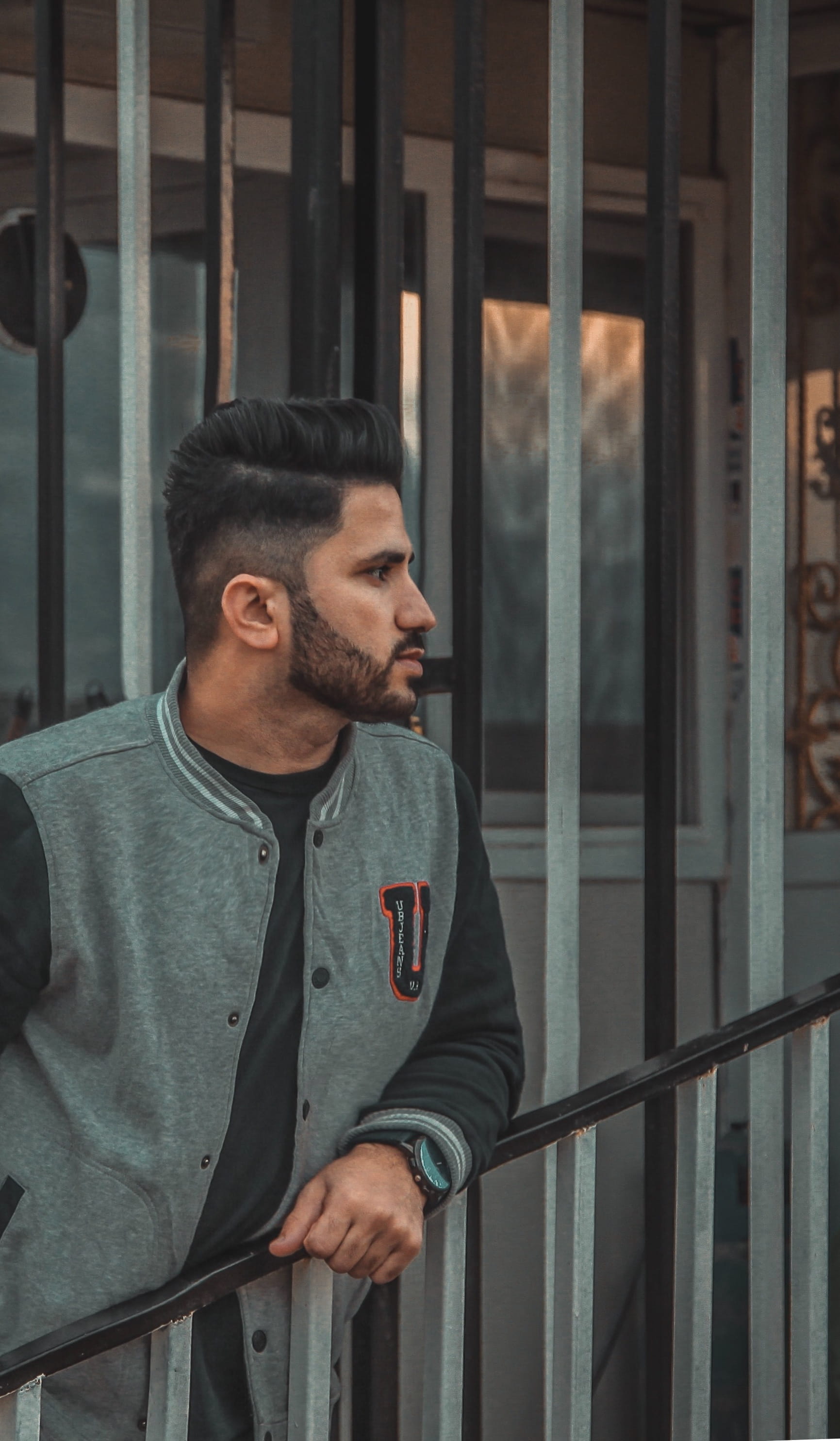 apparel, architecture, door, 2K, real people, waist up, metal, suit, pedestrian, young men, prison, looking, railing, facial hair, casual clothing, near, Phone HD Wallpaper