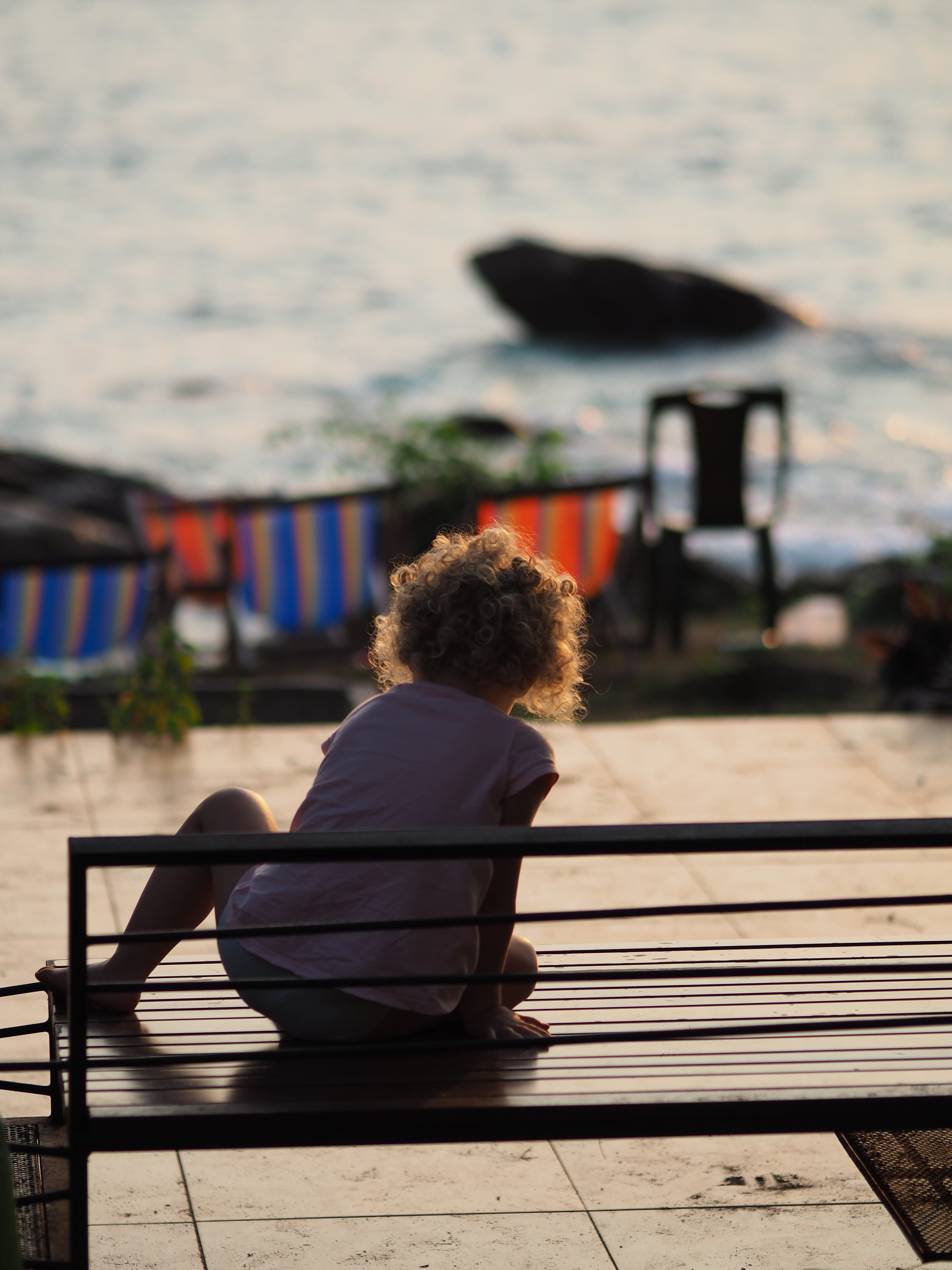 leisure activity, travel, sky, relaxation, lifestyles, bench, curly hair, shadow, sunlight, lonely, backlight, waiting, sitting, childrens playground, focus on foreground, Phone HD Wallpaper