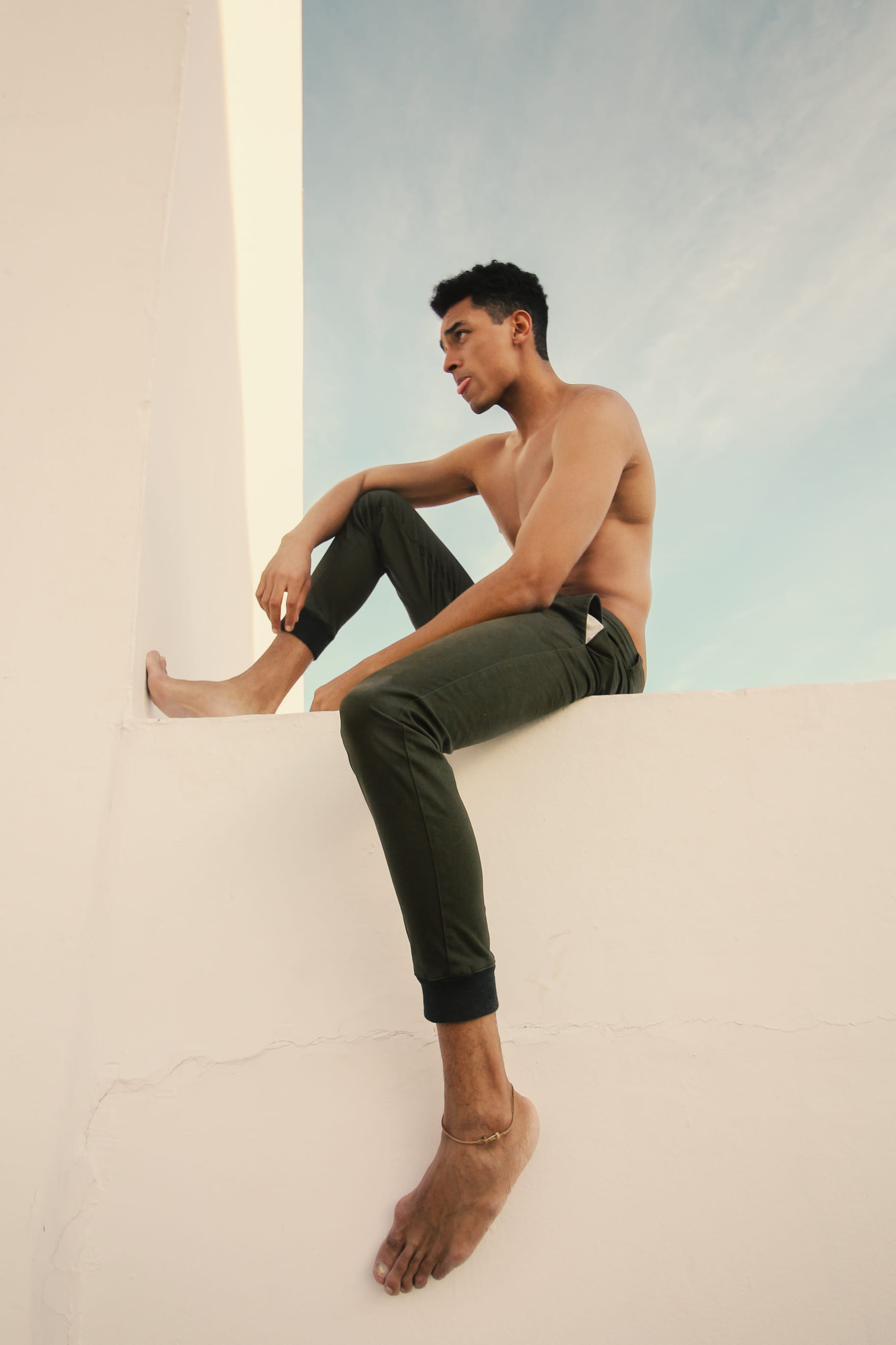 exercising, eyes, urban, pants, 2K, male, looking, outfit, outerwear, s, casual clothing, sitting, posing, males, human, casual, pose, wall, men, photoshoot, Phone HD Wallpaper