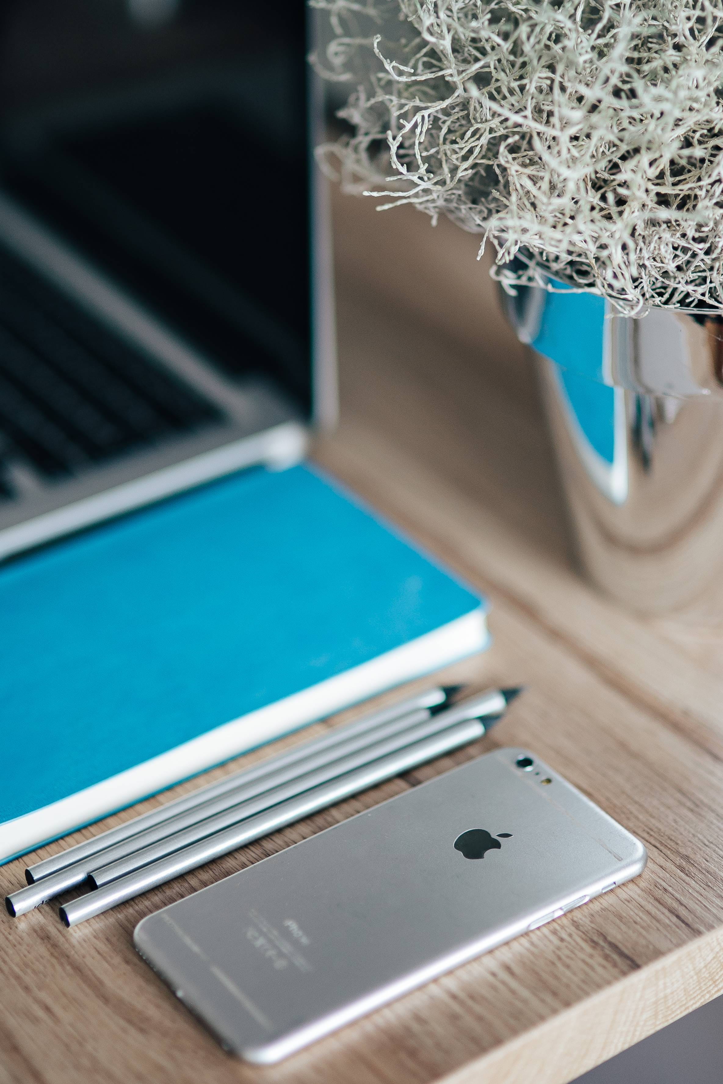 selective focus, iPhone, laptop, notebook, indoors, blue, Apple, focus on foreground, business, notepad, close-up, computer equipment, technology, Silver, Phone HD Wallpaper