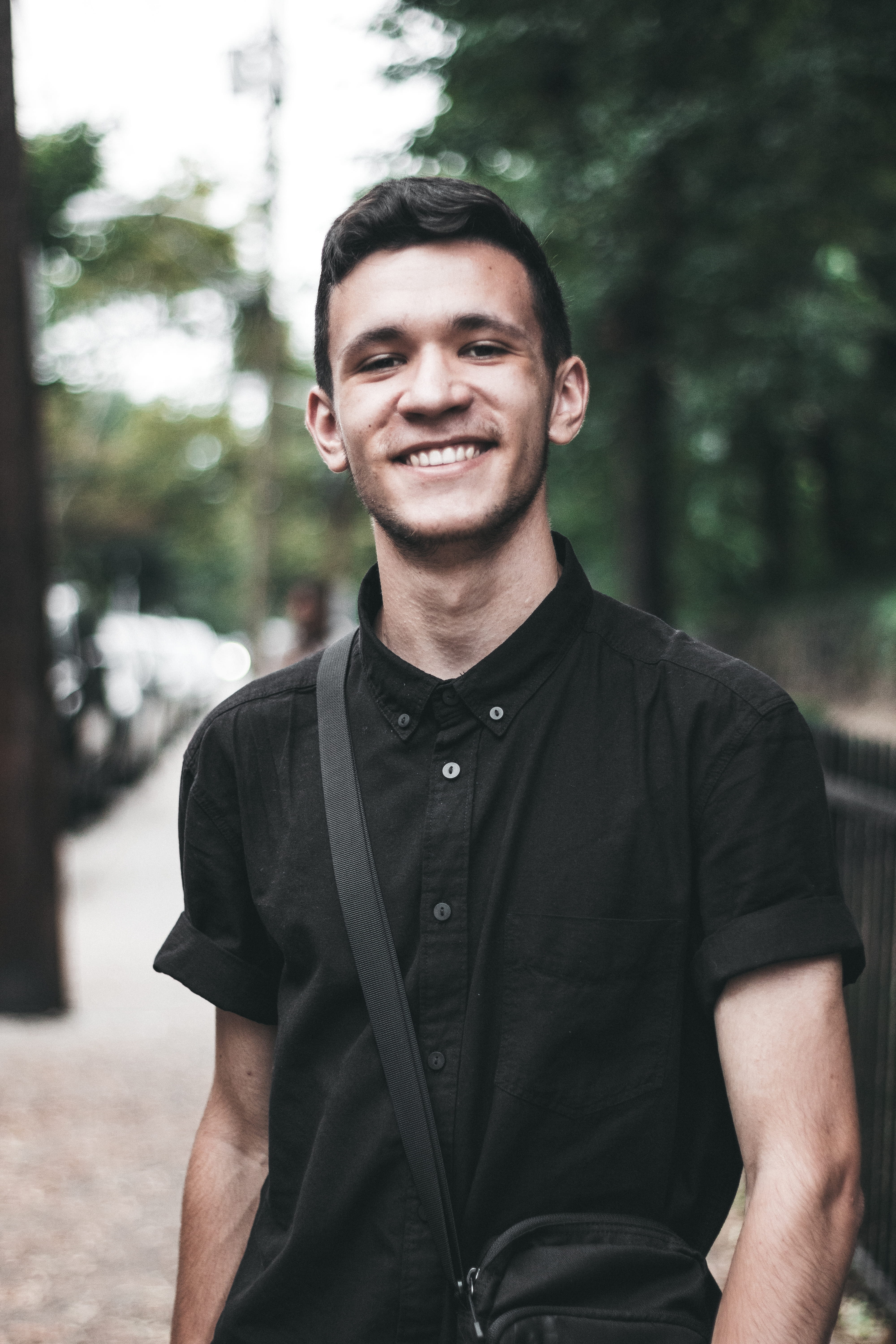 young men, city, new york, standing, happiness, all black, portrait, looking at camera, leisure activity, day, outdoors, 1.4, waist up, ny, smile, one person, Phone HD Wallpaper