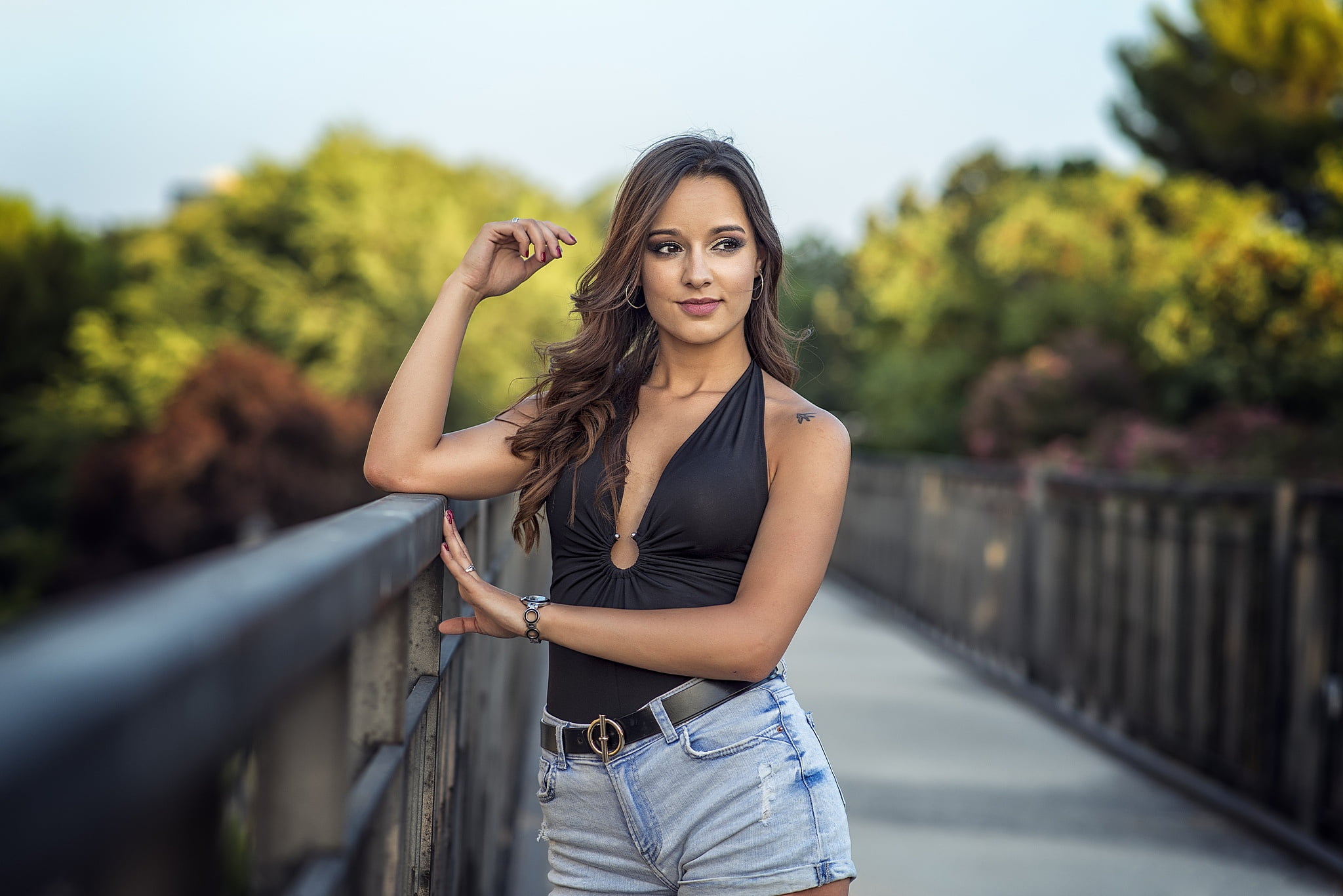 looking away, portrait, mouth, jean shorts, shorts, top, women, depth of field, hoop earrings, Lucia, long hair, model, Black top, dark eyes, tattoo, cleavage, HD Wallpaper