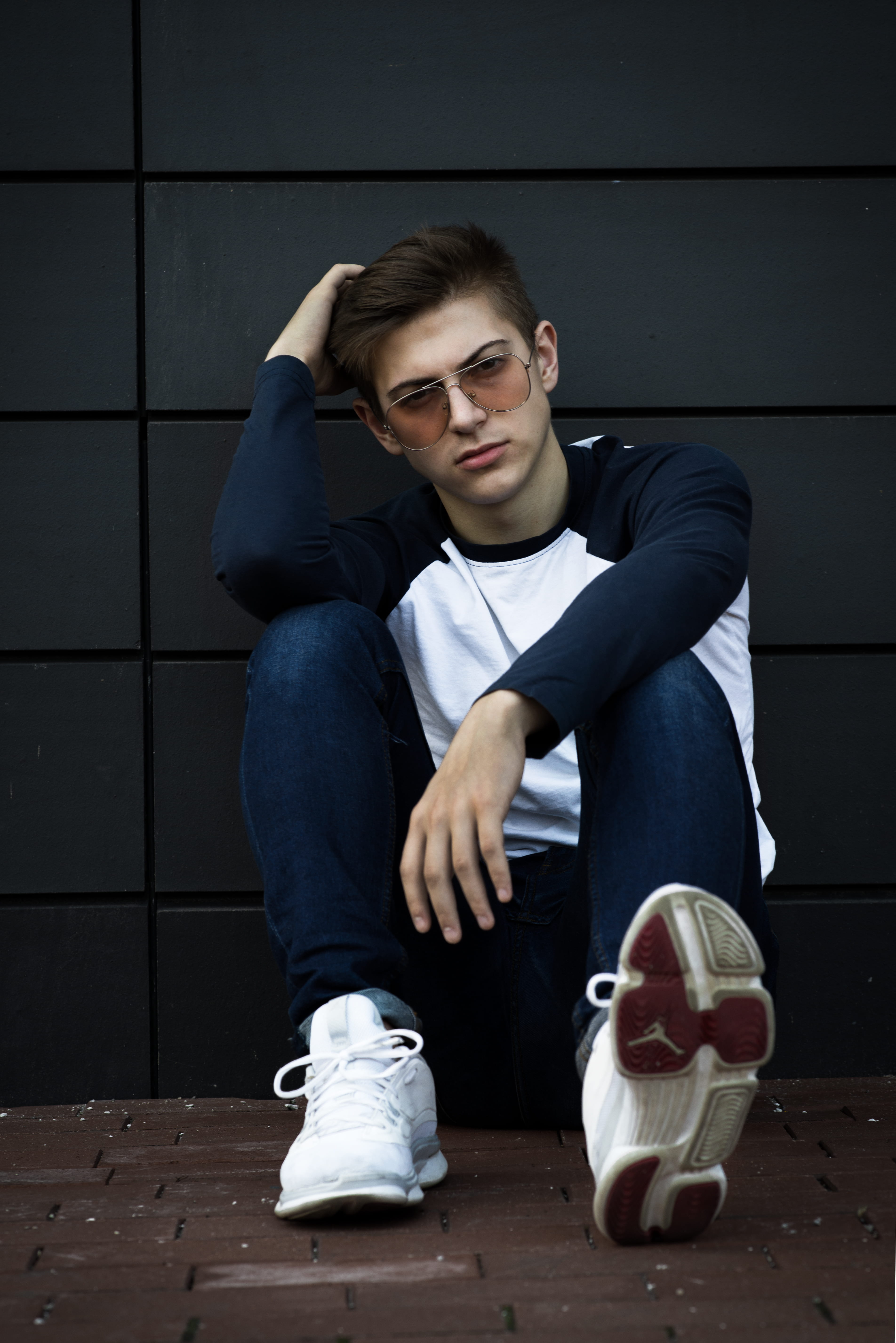 full length, day, casual clothing, contemplation, real people, blue, wall, men, lifestyles, leaning, sat, floor, urban, teenager, holding, jeans, sunglasses, Phone HD Wallpaper