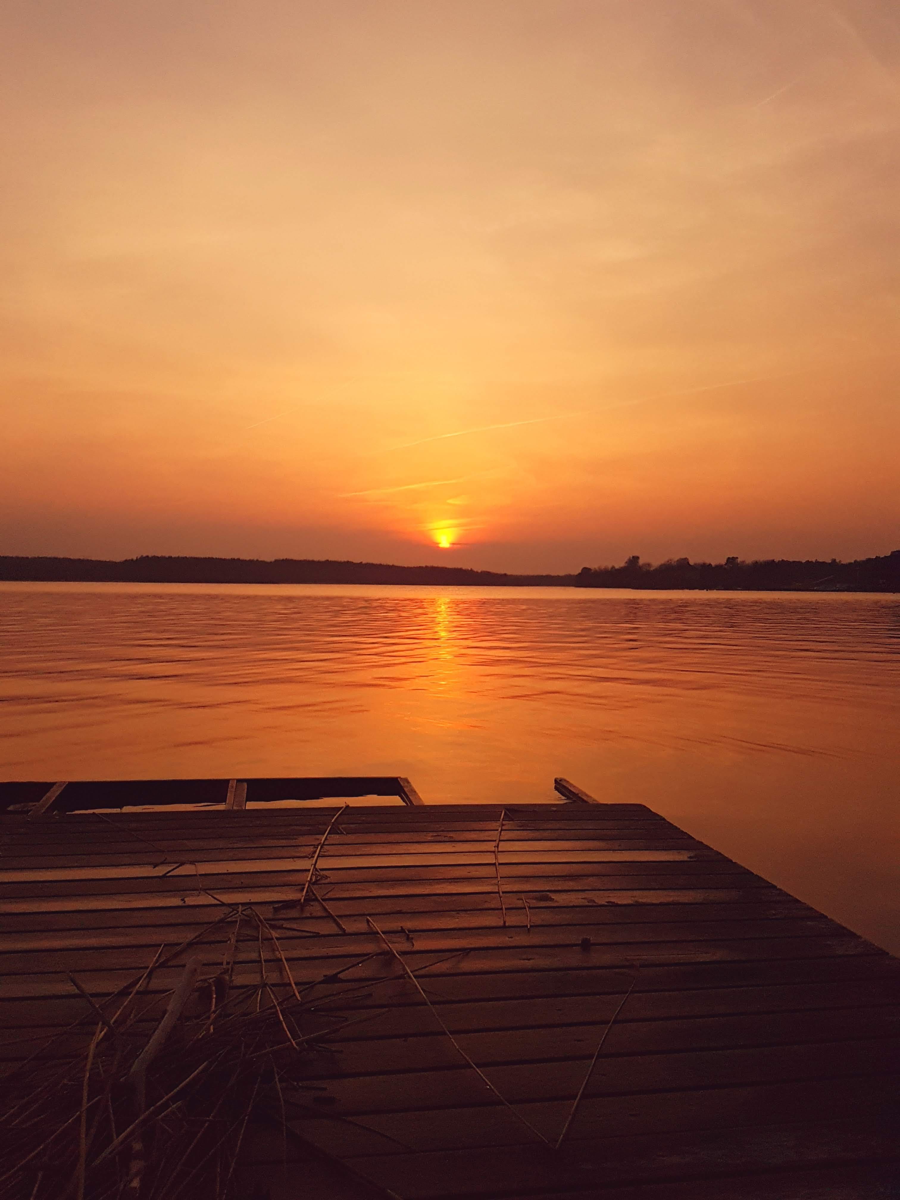 dock, no people, sky, orange color, sun, wood, pier, boardwalk, horizon, red sky, reflection, light, sunlight, 4K, outdoors, body, non-urban scene, beauty in nature, Phone HD Wallpaper