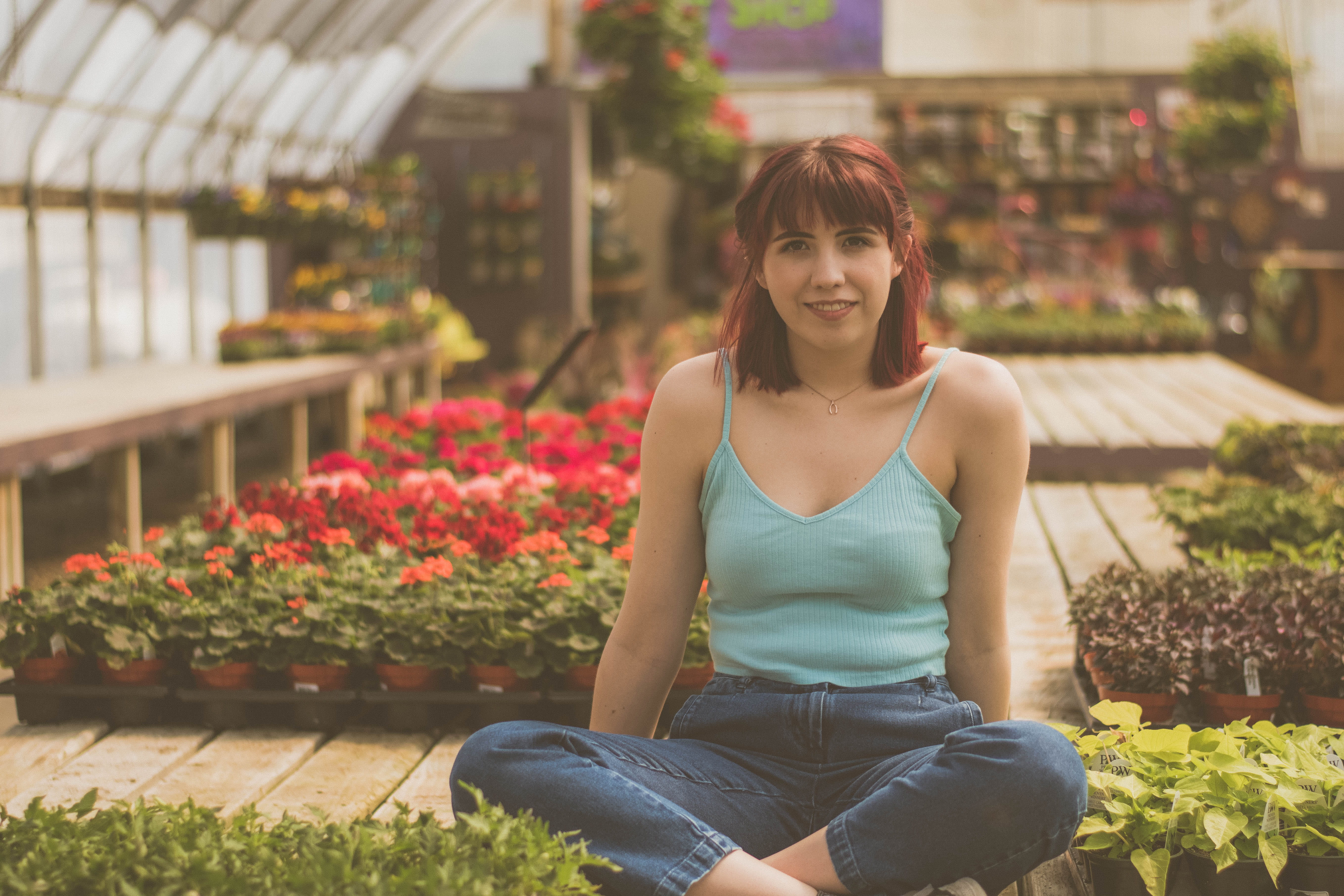 gardening, casual clothing, girl, freshness, denim jeans, fashion, smiling, looking at camera, tank top, garden, women, sat, plant, red head, beside, front view, HD Wallpaper