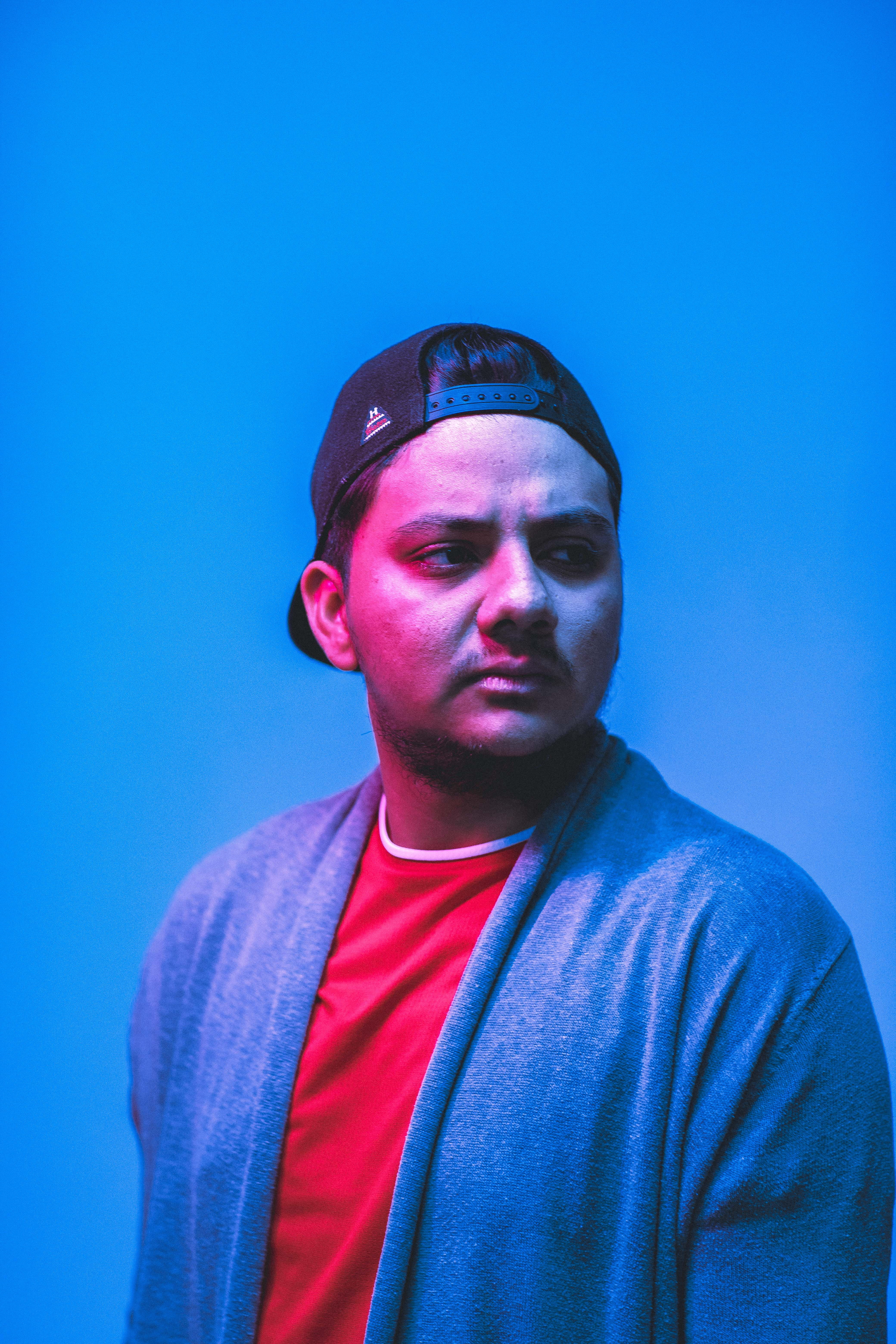 pose, standing, young men, blue background, youth, looking at camera, wear, person, looking, bad, young adult, cap, cardigan, man, young, sweatshirt, urban, Phone HD Wallpaper