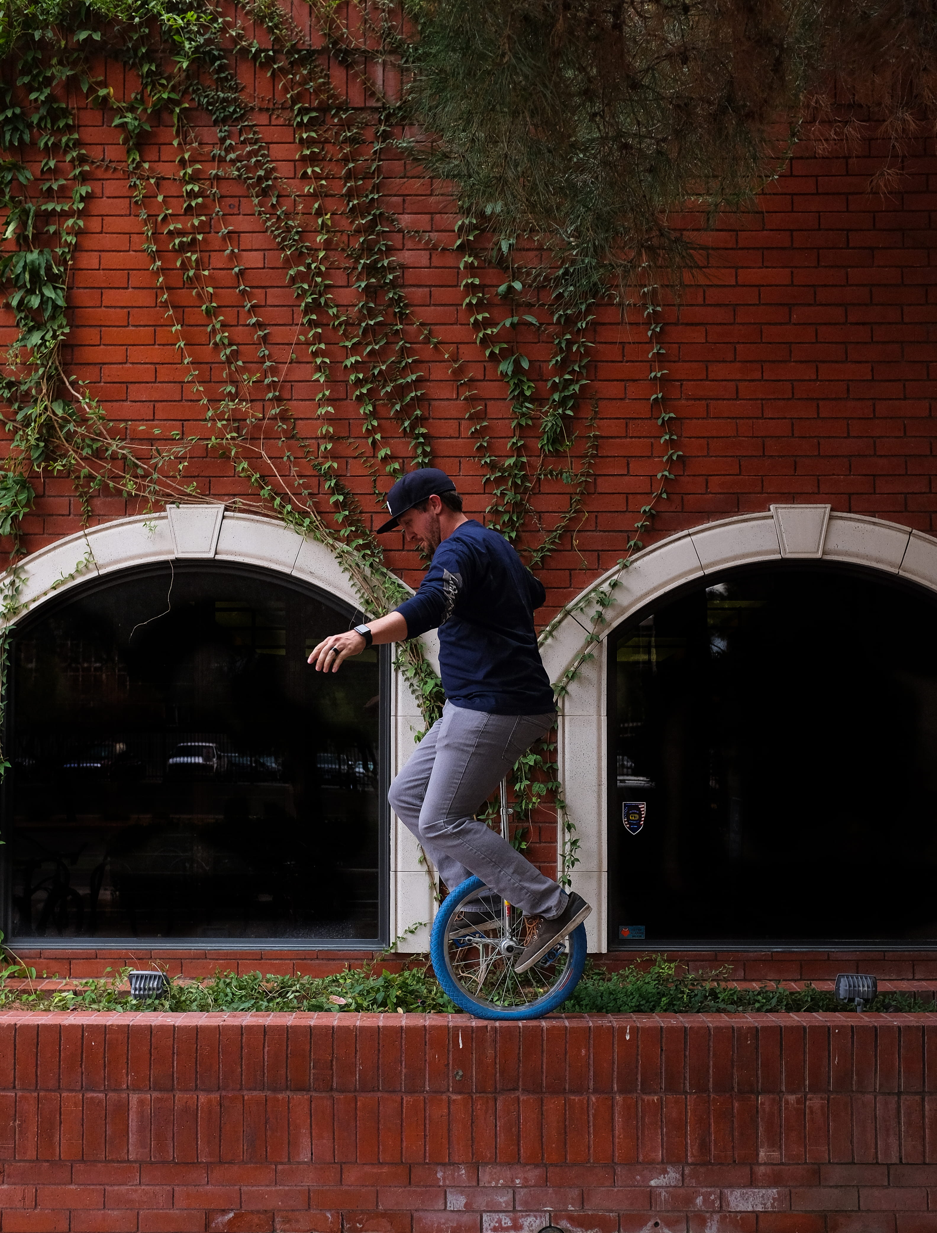 brick, red, 4K, plant, green, unicycle, dangerous, united states, mode of transportation, wall, casual clothing, lifestyles, real people, full length, Phone HD Wallpaper