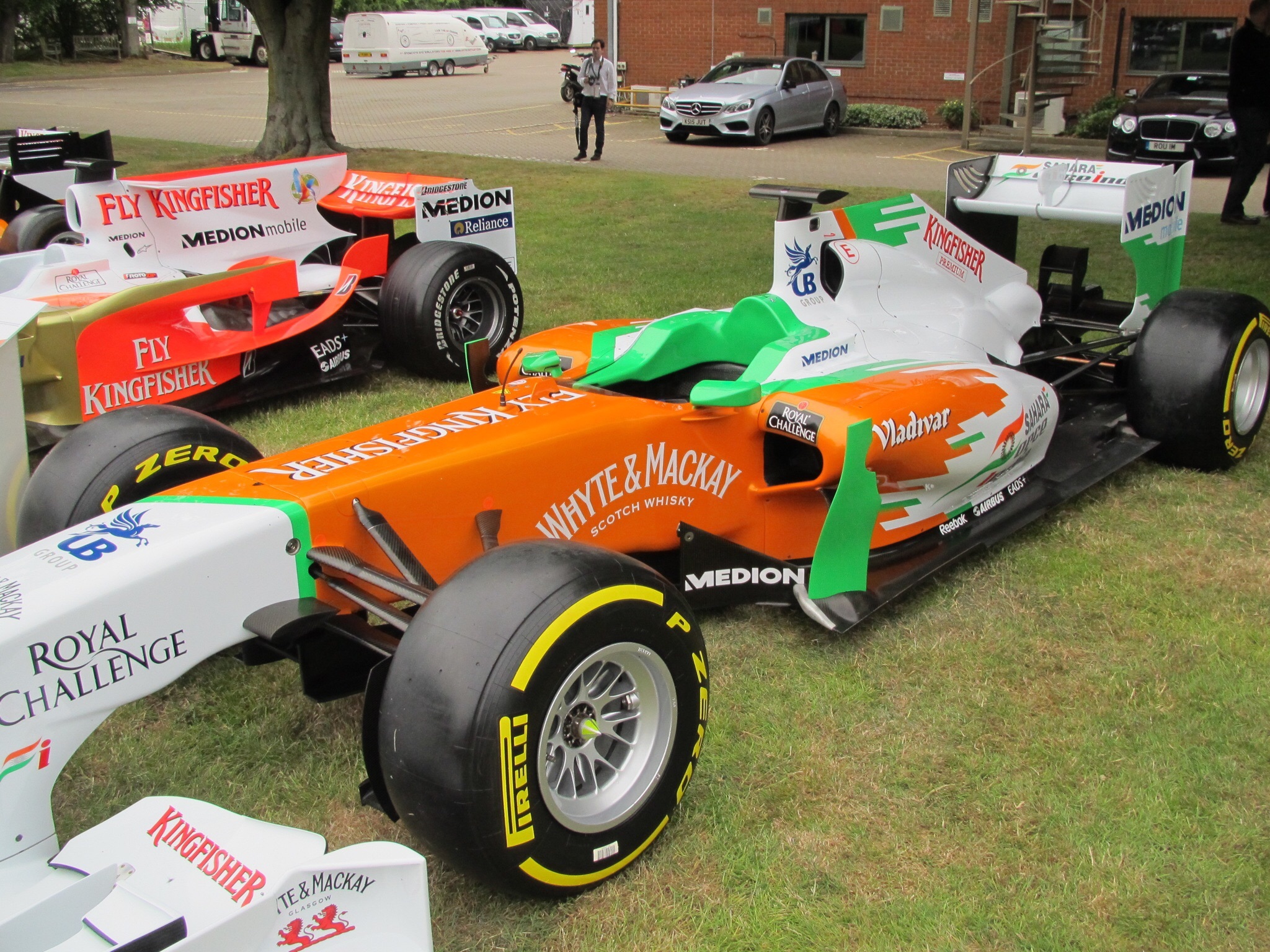 grass, car, 1080P, communication, land vehicle, race care, transportation, sports race, f1, incidental people, city, competition, text, street, force india, HD Wallpaper