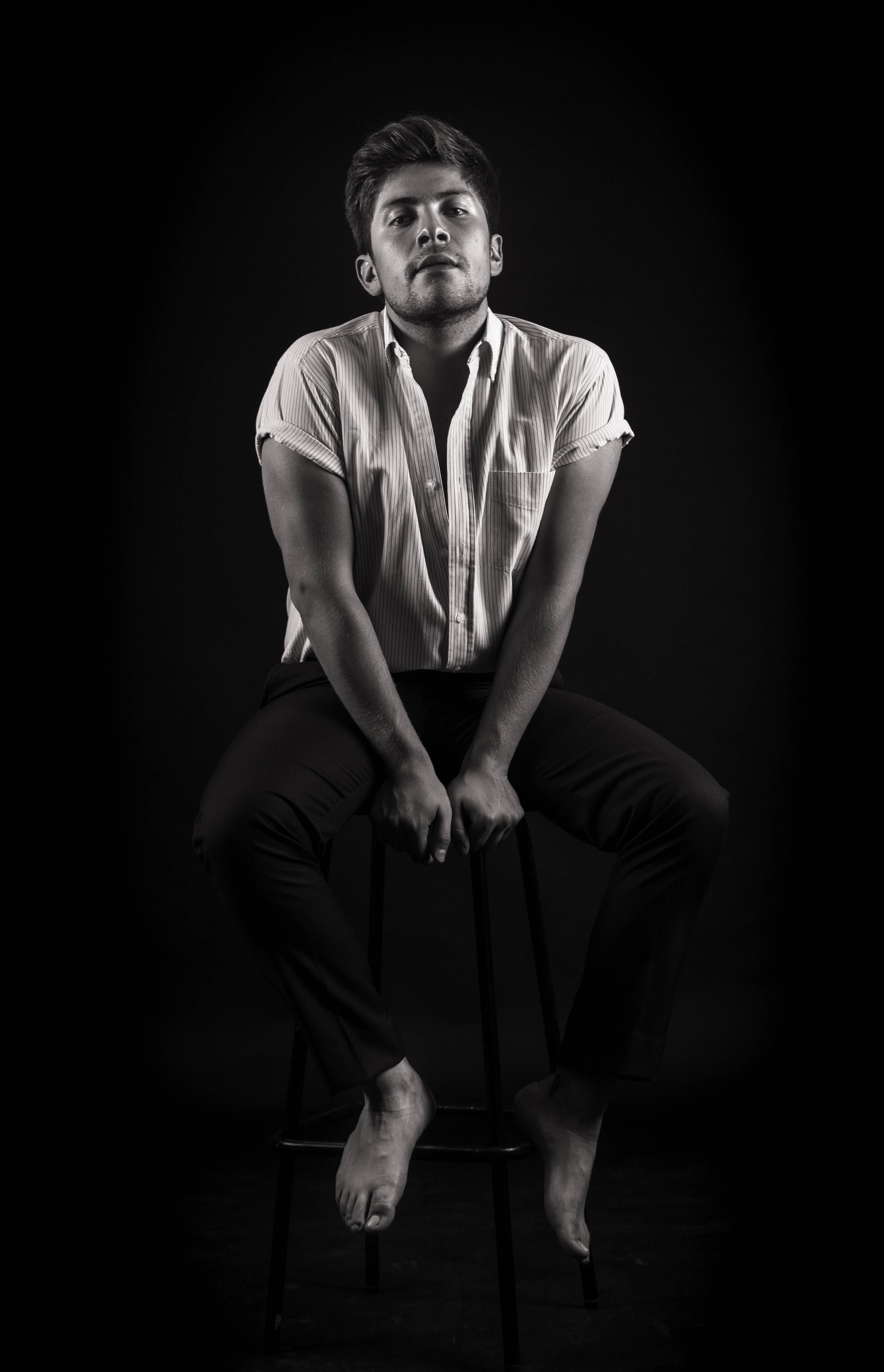 finger, arm, looking at camera, studio shot, indoors, jaw, black background, casual clothing, sitting, 5K, one person, cut out, seat, full length, photo, Phone HD Wallpaper