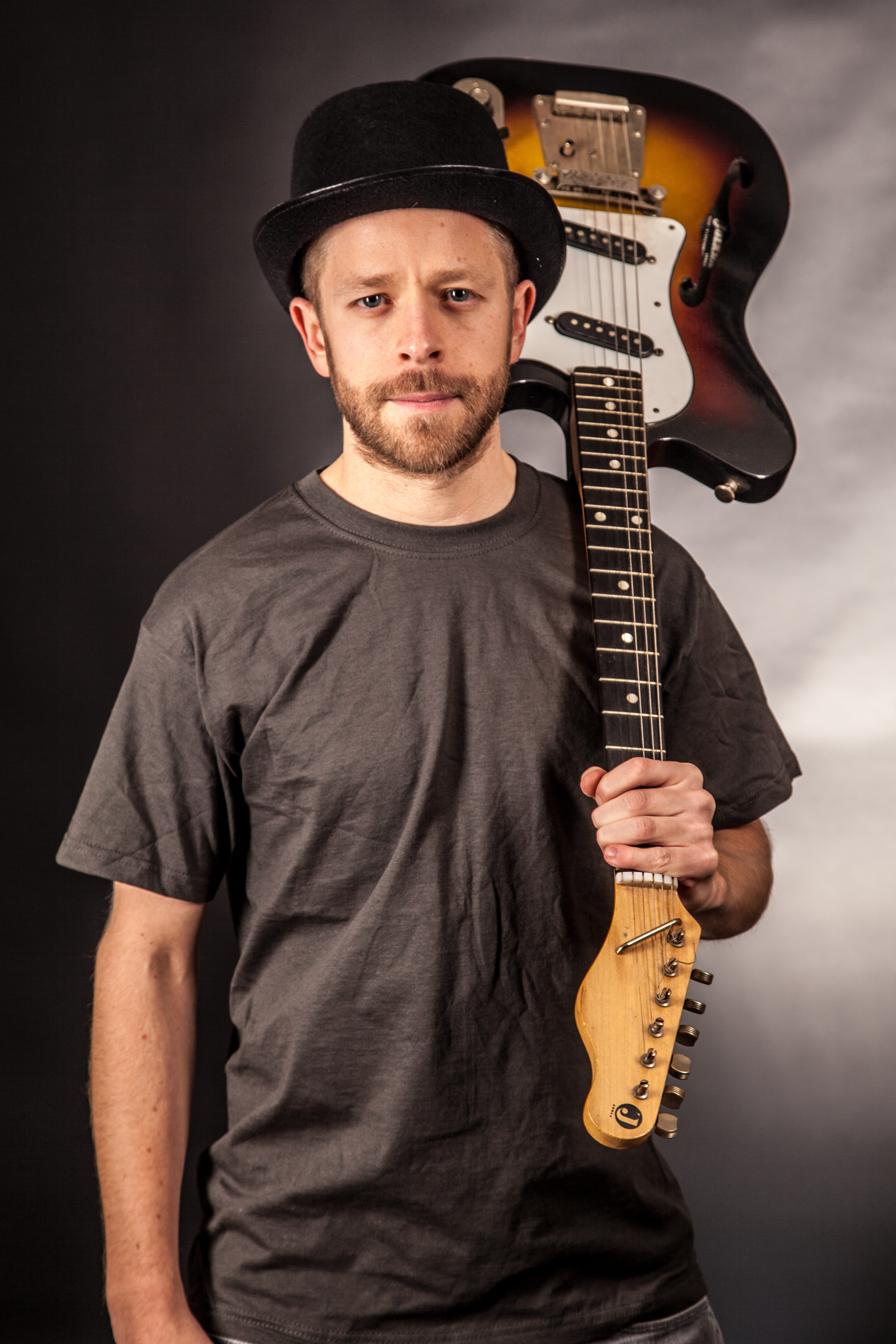 hat, studio shot, standing, musician, looking at camera, artist, electrically, 5K, instrument, electric, play, t, front view, musical instrument, holding, Phone HD Wallpaper