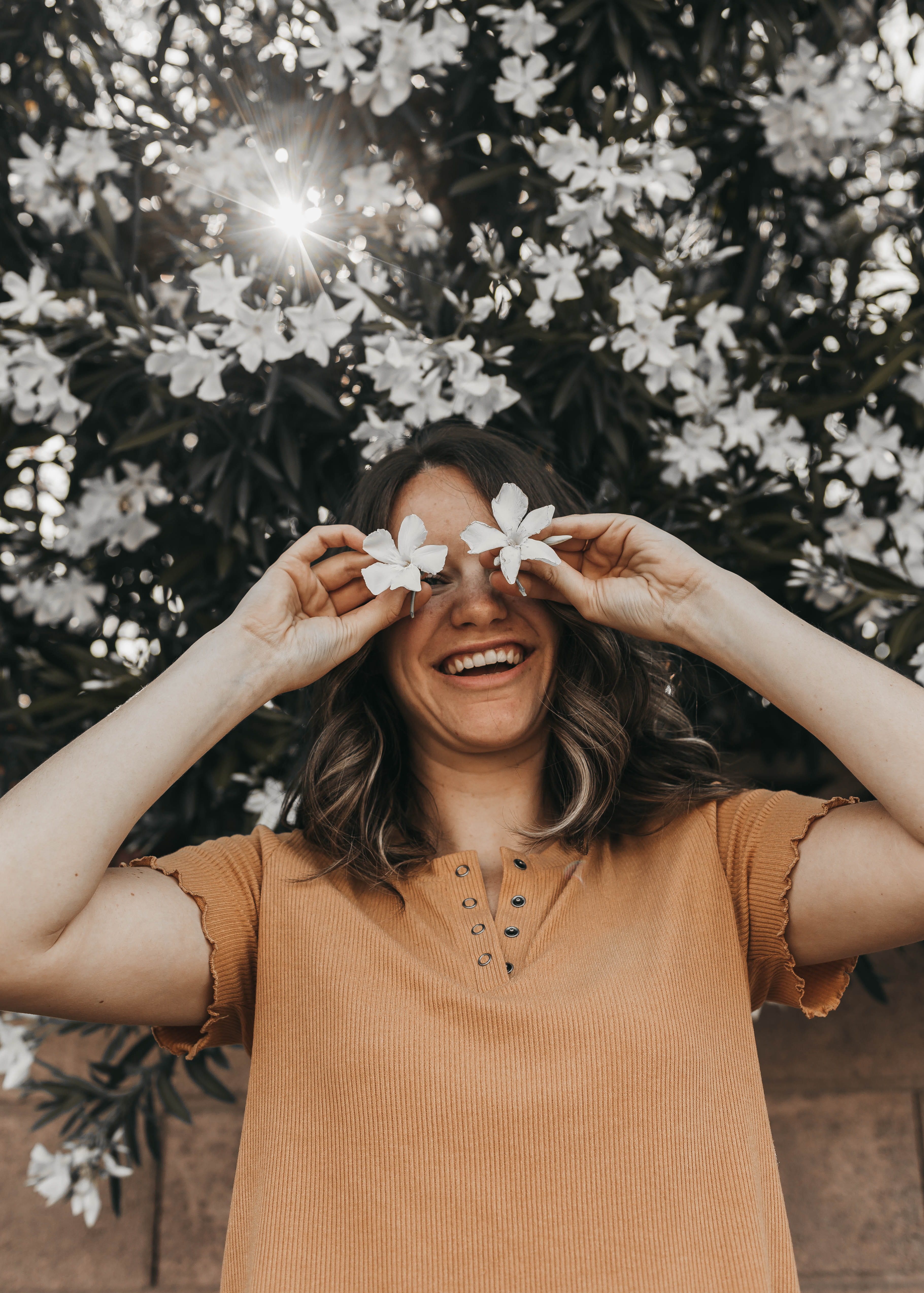 face, cheerful, plant, mouth open, positive emotion, 4K, smiling, looking at camera, young adult, outdoors, toothy smile, flower, apparel, nail, young women, Phone HD Wallpaper