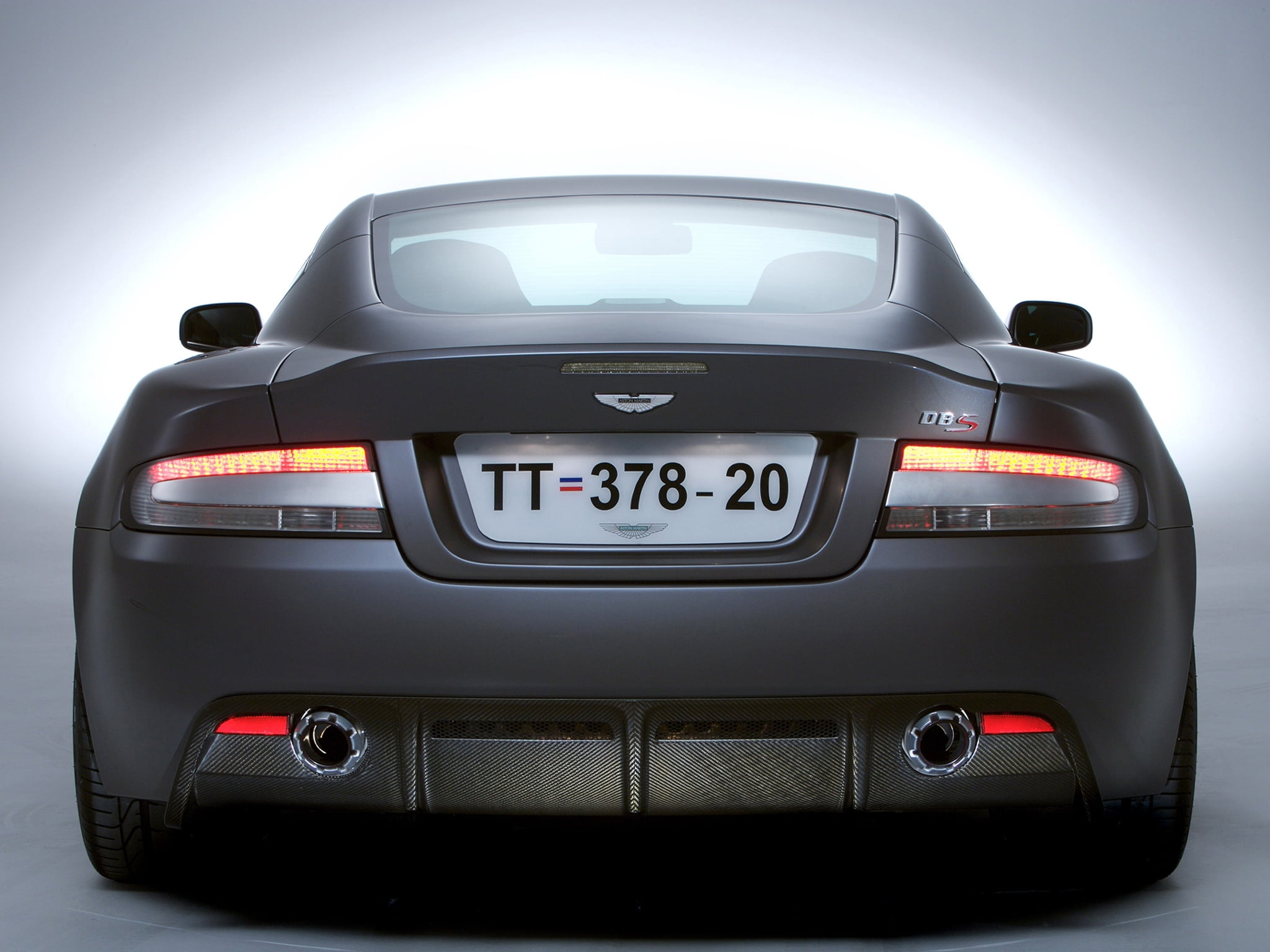 black, shiny, small, motor Vehicle, mode of transportation, modern, safety, security, 1080P, indoors, wheel, aston martin, aston, rear view, communication, HD Wallpaper