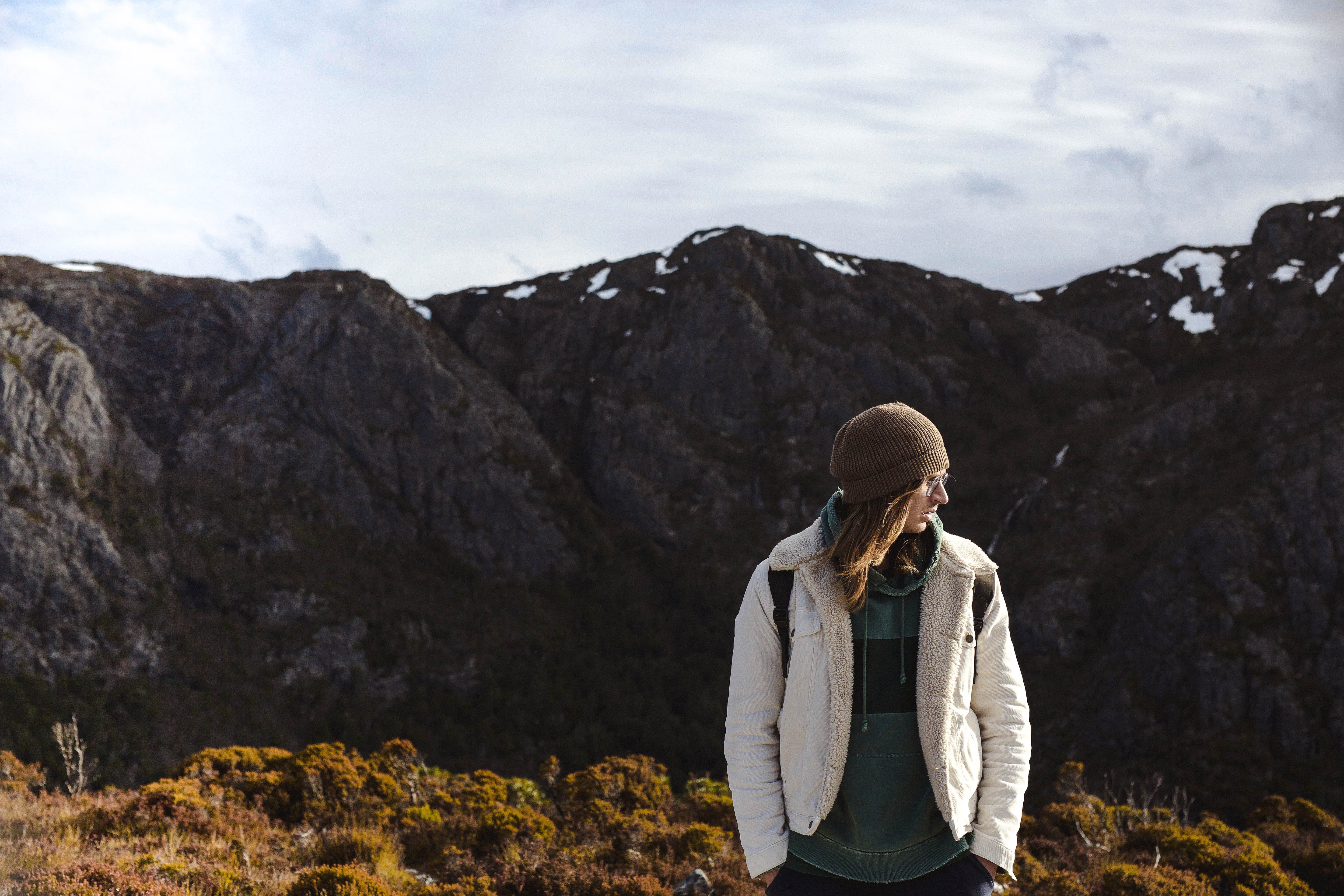 human, 5K, nature, clothing, looking at view, person, coat, blazer, one person, man, cloud - sky, rock, rock - object, jacket, real people, outdoors, leisure activity, HD Wallpaper