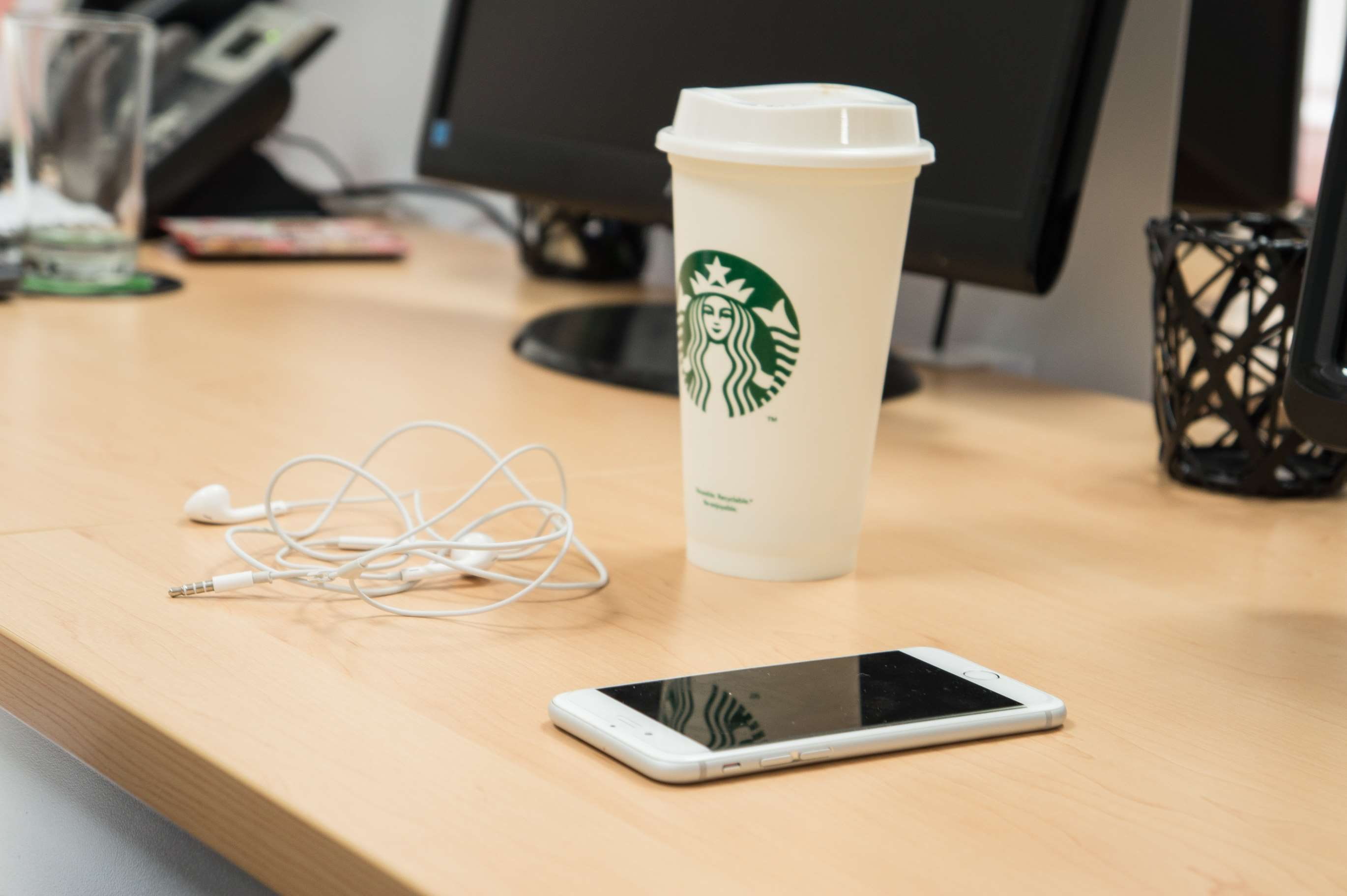 screen, focus on foreground, office, container, cup, starbucks, portability, iphone, portable information device, connection, earbuds, 2K, coffee, table, HD Wallpaper