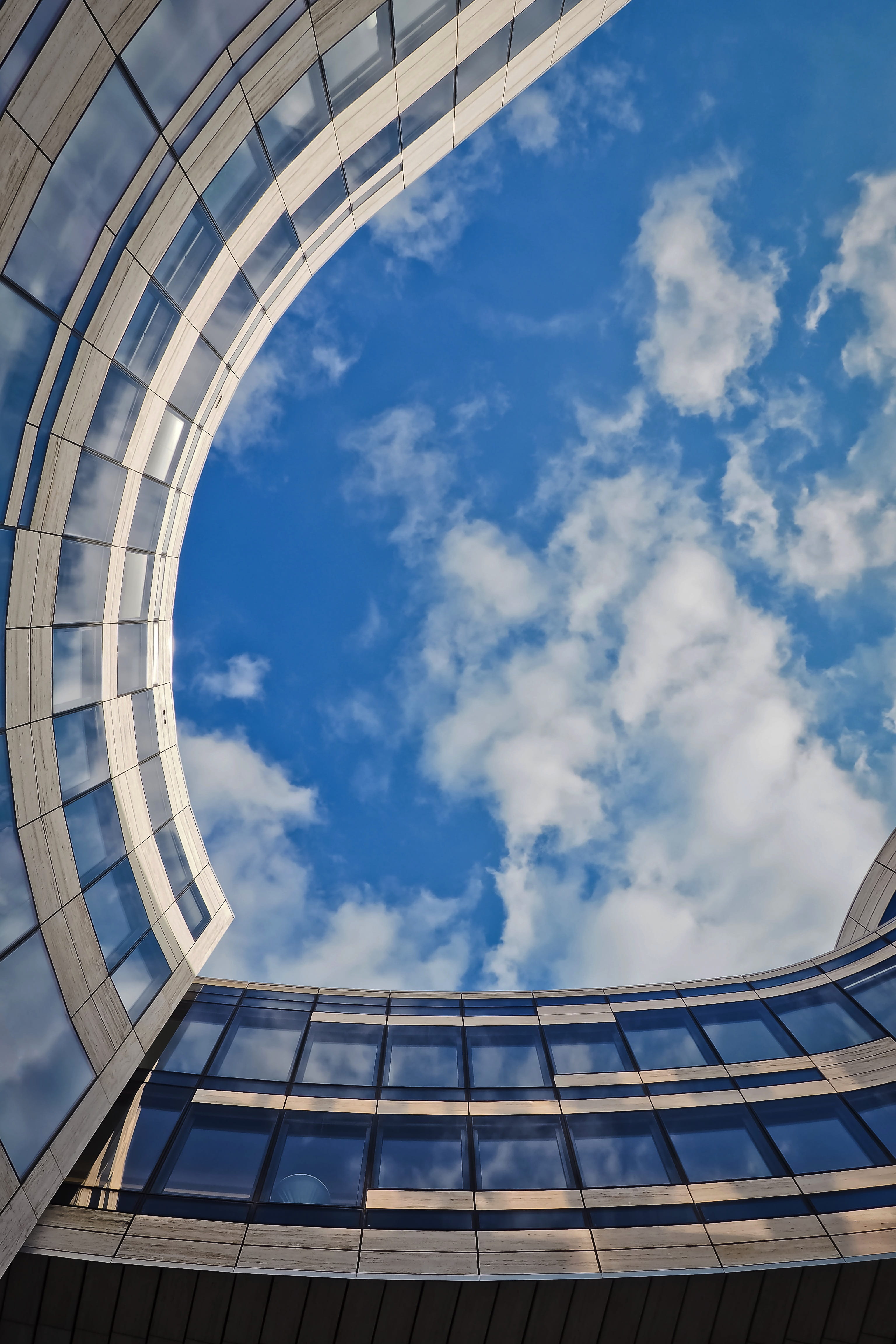 clouds, modern, low angle view, glass - material, office building, pattern, city, modern architecture, facade, cloud - sky, roof, structure, directly below, Phone HD Wallpaper