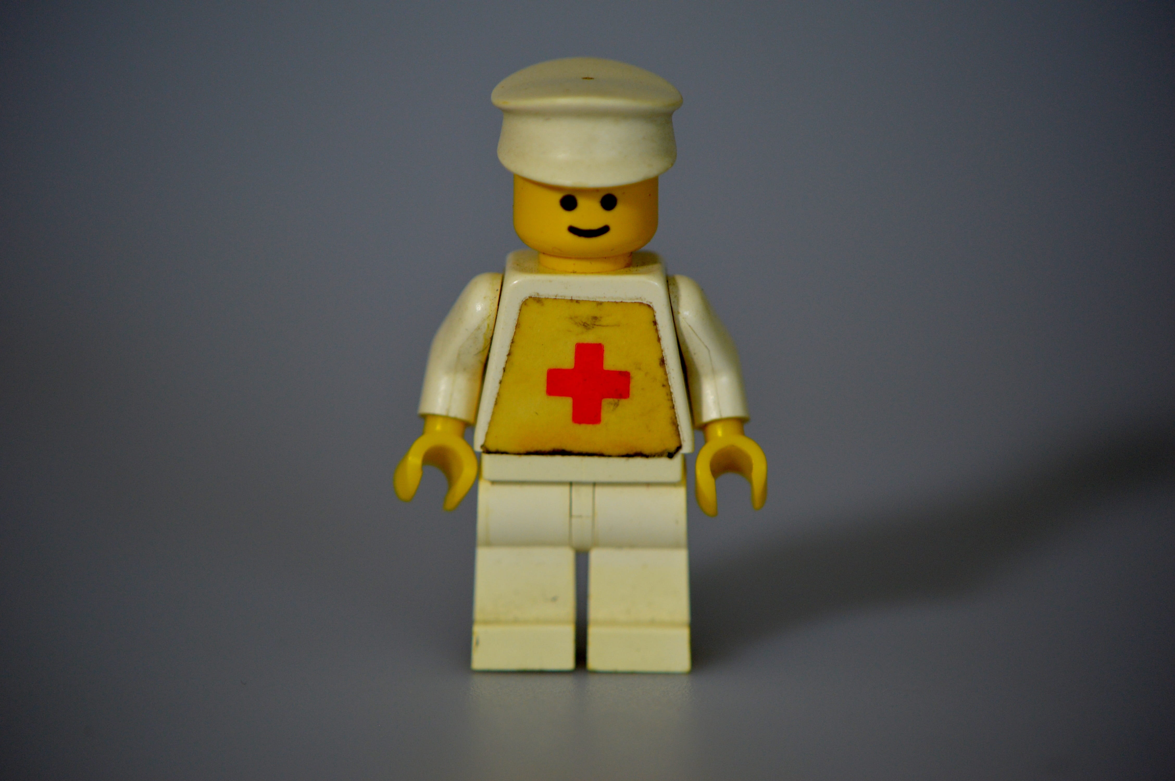 colored background, gray background, single object, close-up, toy, indoors, yellow, 4K, Lego, blue background, still life, building blocks, figure, male likeness, HD Wallpaper