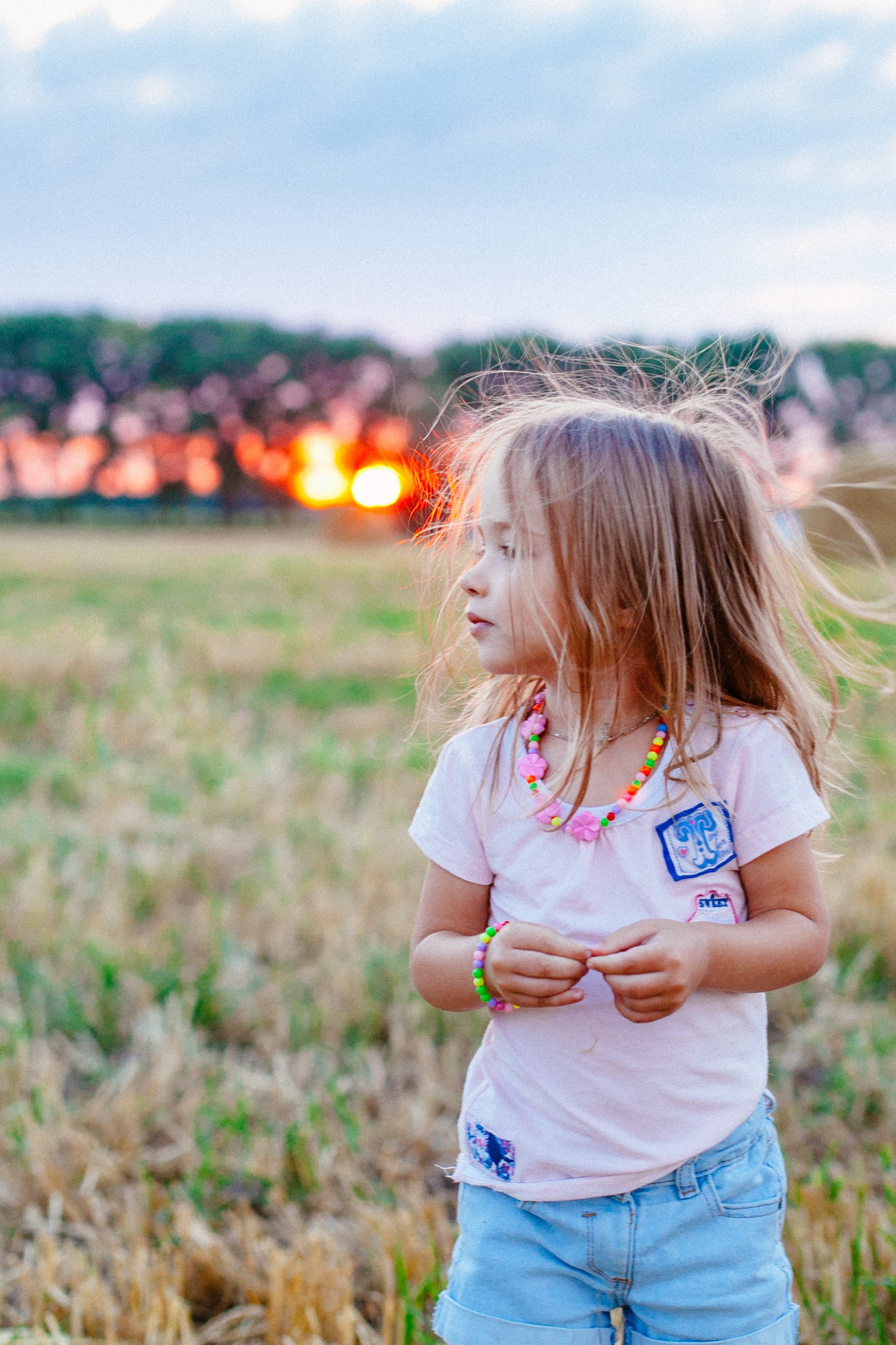 lifestyles, real people, daytime, sunset, baby, small child, females, joy, field, girl, good luck, 2K, childhood, land, sky, child, hay, innocence, the little girl, Phone HD Wallpaper