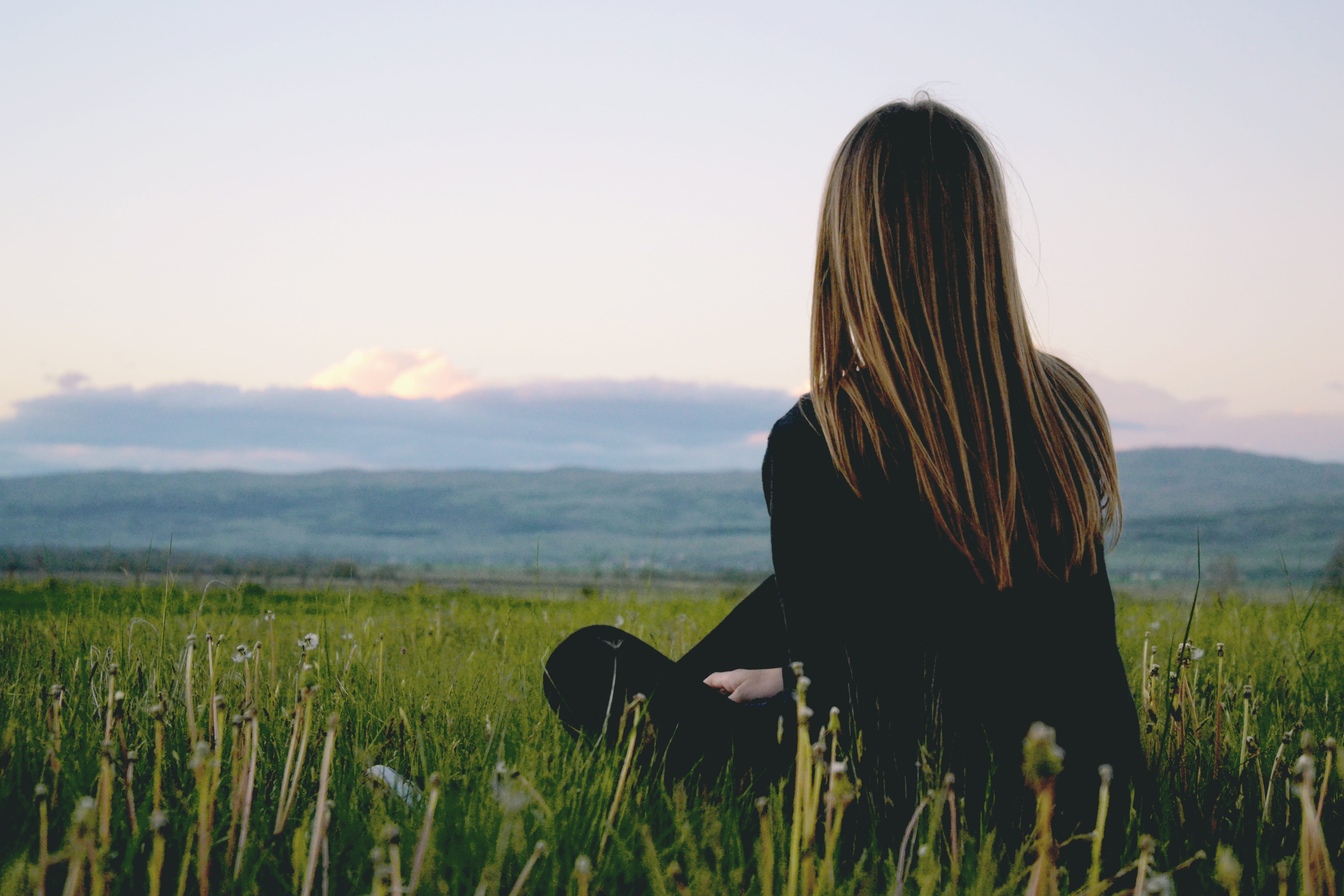 leisure activity, black, mountain, scenics - nature, cloudy, grass, beauty in nature, rural, clear sky, sitting, green, hair, woman, country, scenic, women, HD Wallpaper