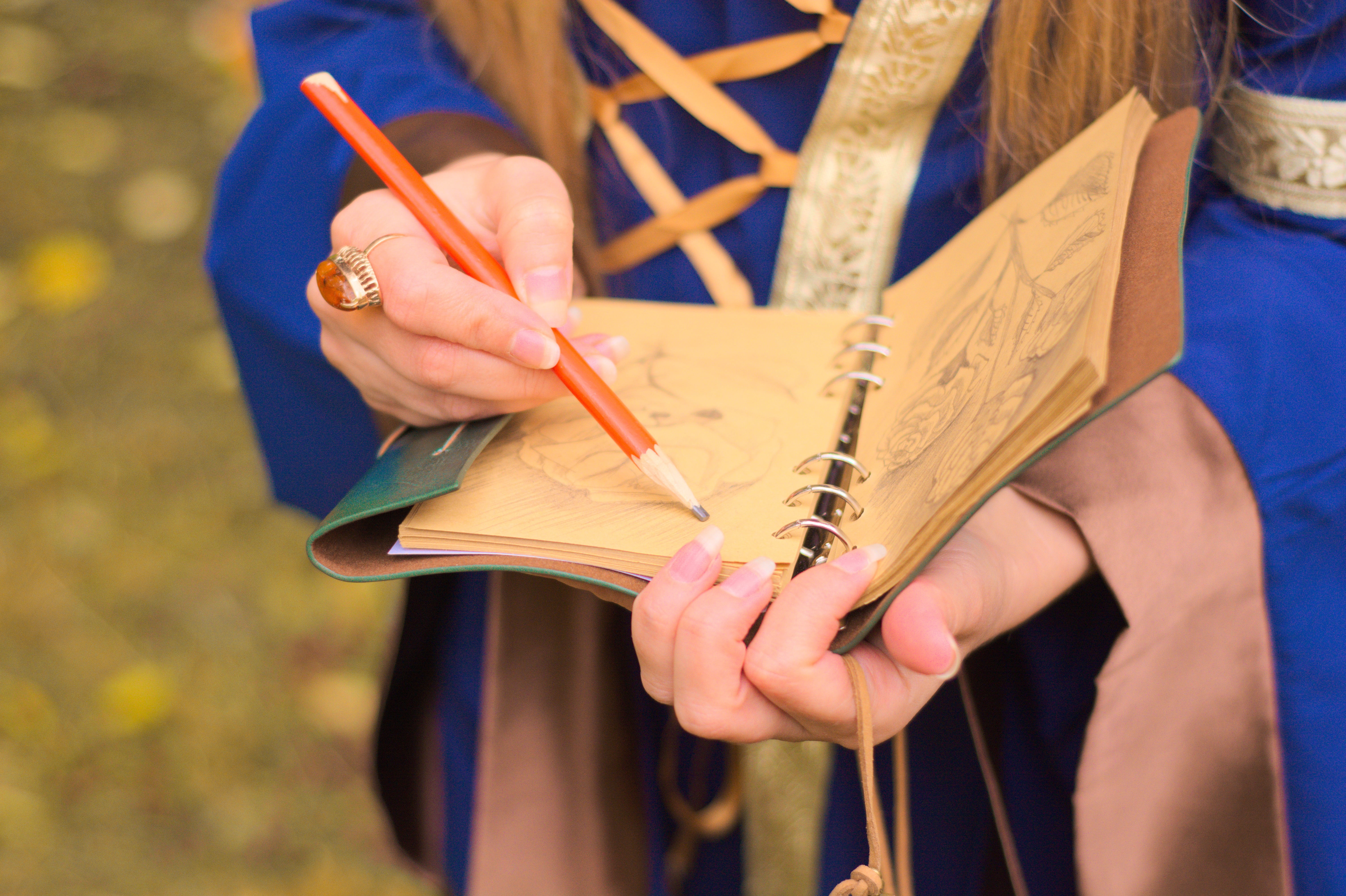 pen, adult, focus on foreground, book, historical, legend, medieval way, fabulously, holding, magic forest, orange, human body part, art and craft, nature, HD Wallpaper