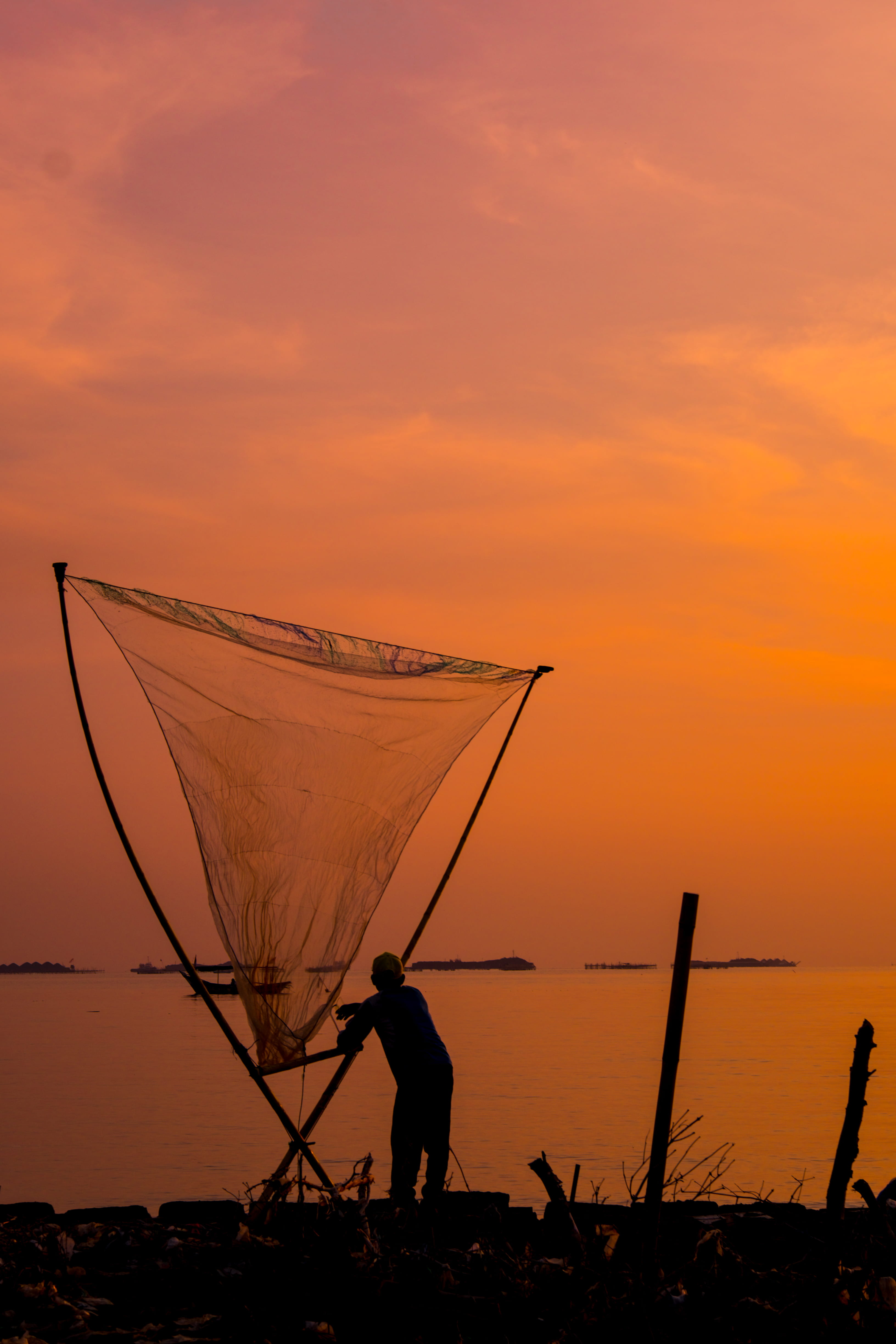 4K, fishing industry, scenics - nature, men, one person, lifestyles, orange color, net, fishing net, man, beauty in nature, nature, silhouette, orange sky, Phone HD Wallpaper