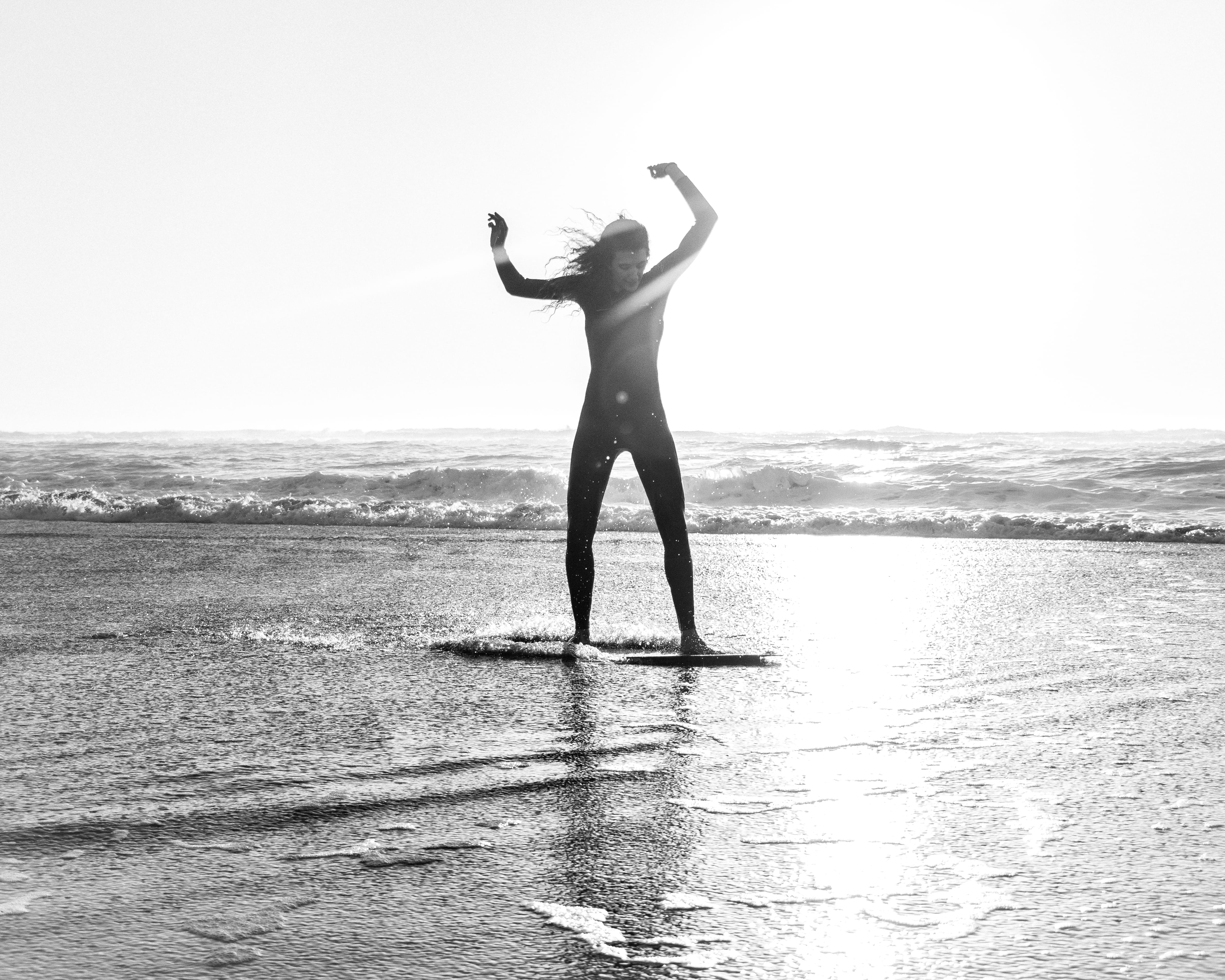 water sport, girl, greyscale, standing, real people, sun, sky, skim, woman, horizon over water, beach, riding, scenics - nature, horizon, sea, boogie board, HD Wallpaper