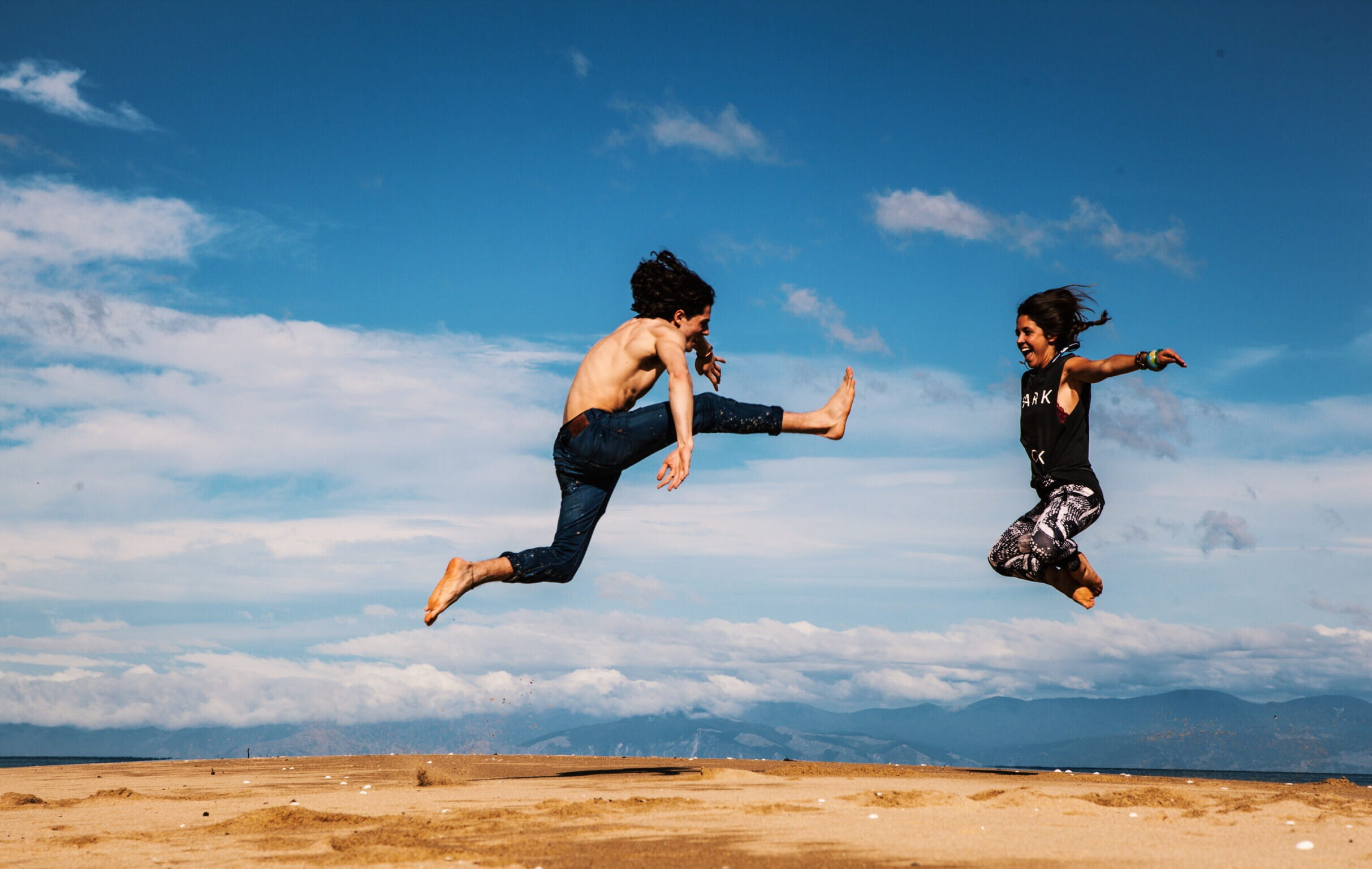 freedom, summer, mid-Air, cheerful, land, cloud - sky, hanging, males, outdoors, couple - relationship, sand, kick, motion, happiness, nature, togetherness, HD Wallpaper