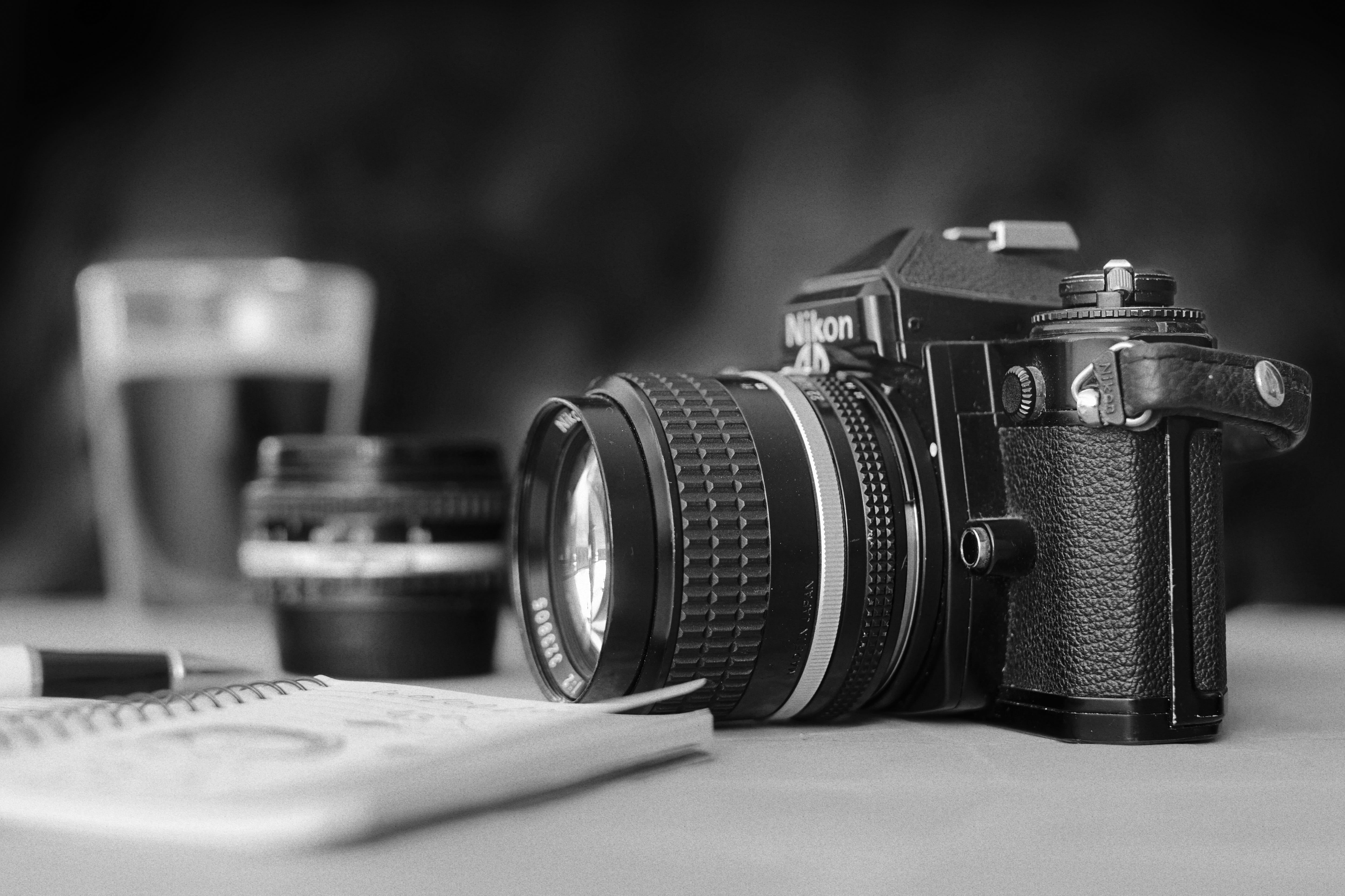 photography, table, retro, monochrome, lens - optical instrument, camera - photographic equipment, pen, white, coffee, focus on foreground, leisure, 5K, HD Wallpaper