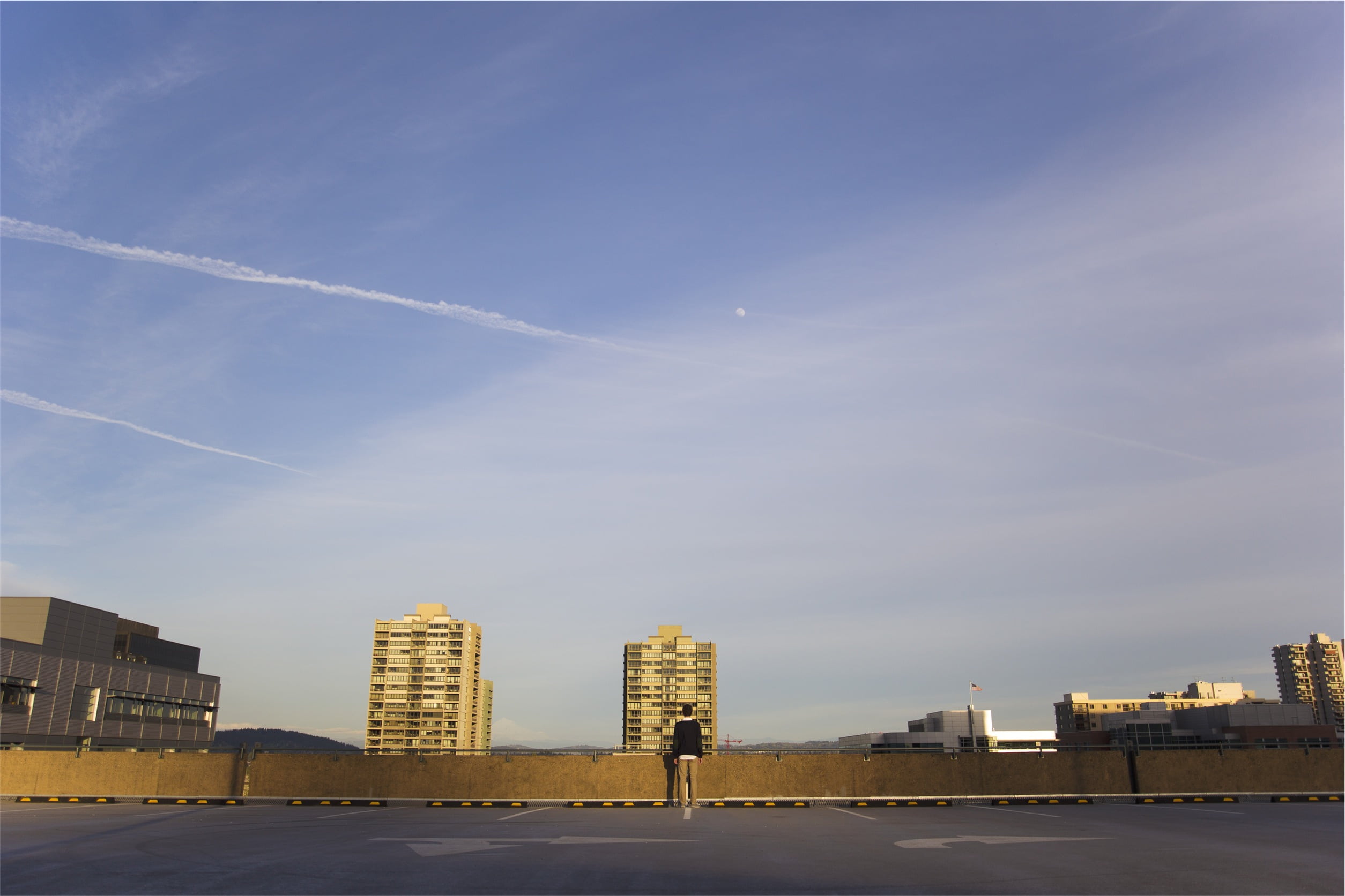 standing, near, modern, urban skyline, guy, apartments, building, people, front, vapor trail, city, man, 1080P, no people, high, cloud - sky, barricade, HD Wallpaper