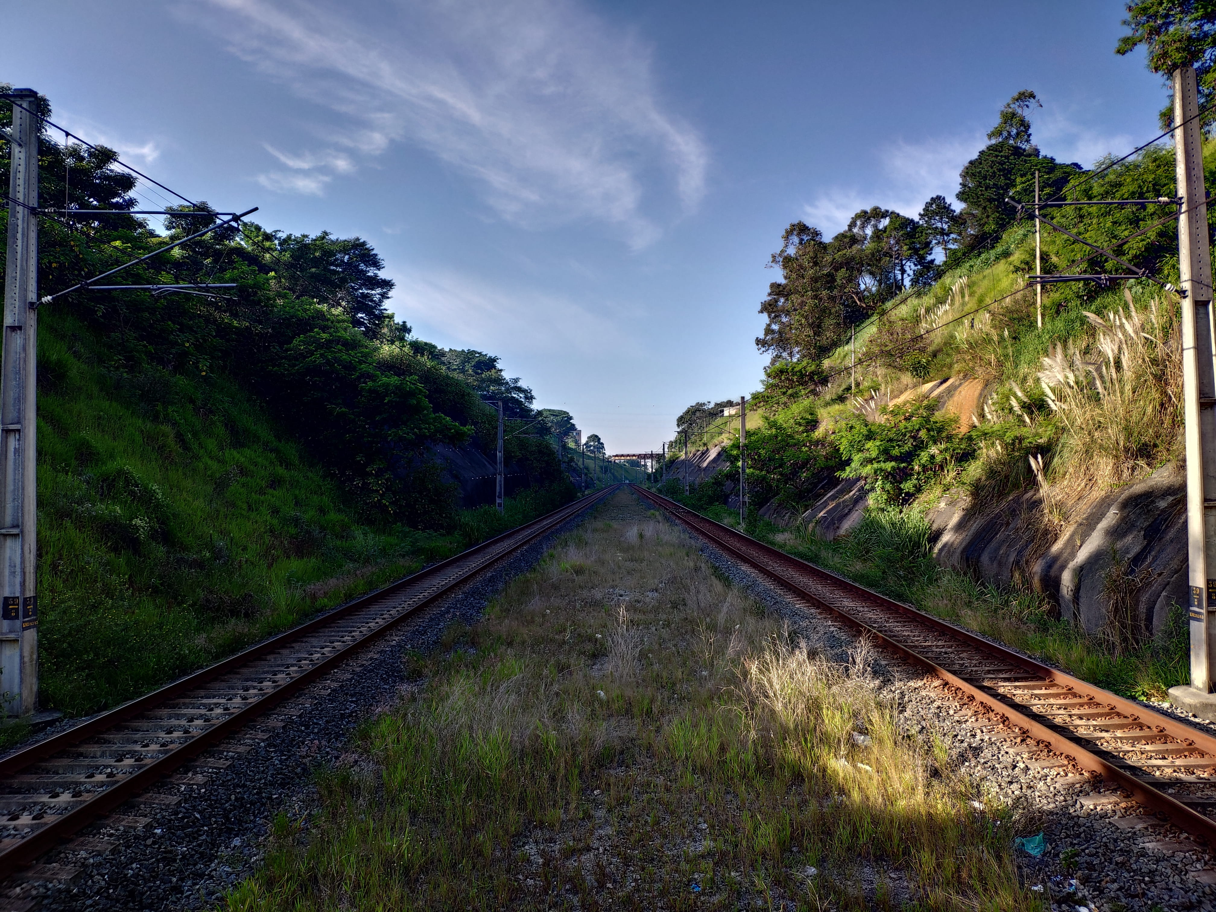 long, train track, scenery, grass, transportation, railway, gravel, vanishing point, railroad track, outdoors, cloud - sky, dirt road, slate, no people, HD Wallpaper