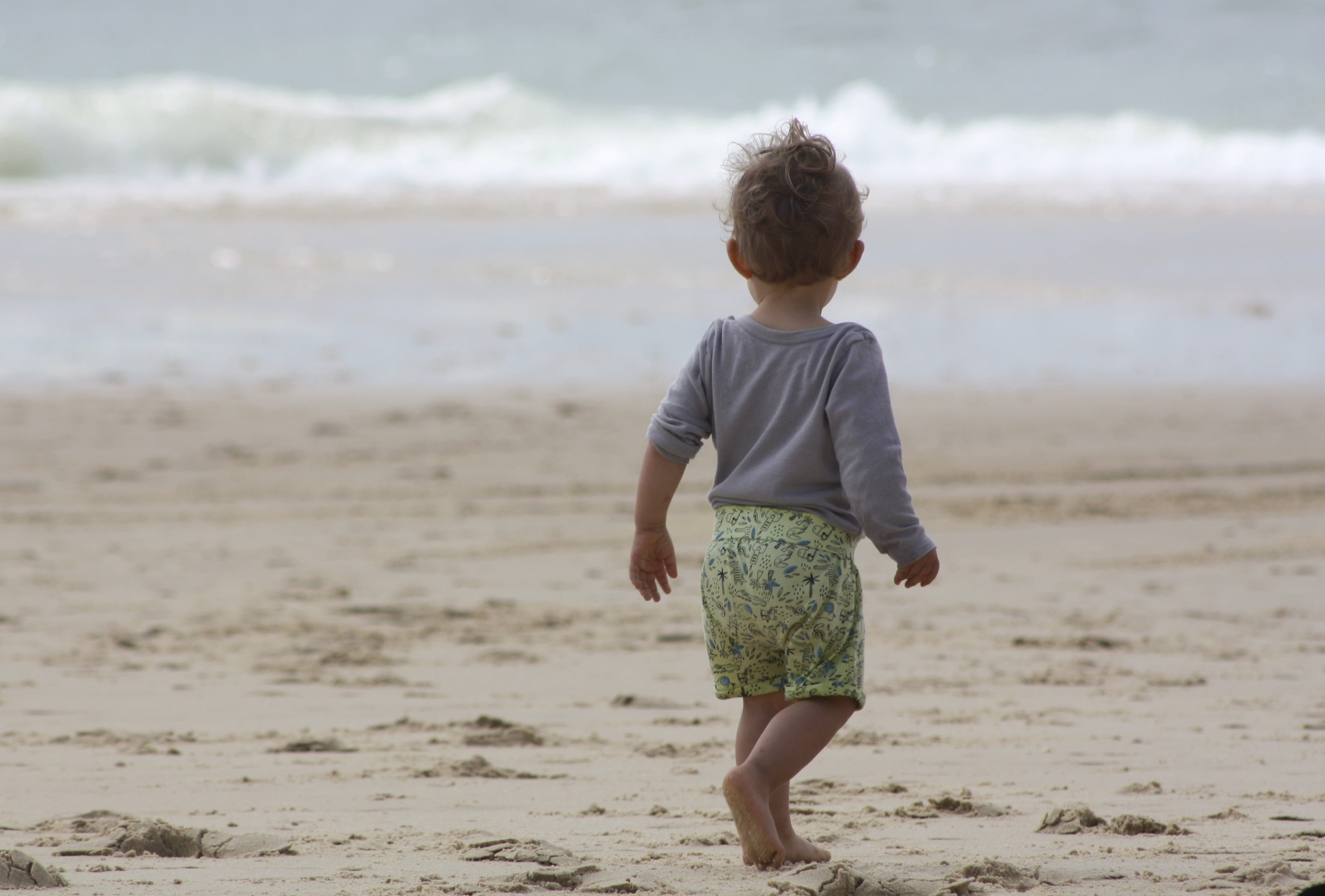 innocence, facing the sea, ocean, land, sea, near, water, beach, leisure activity, real people, relaxation, holiday, toddler, shore, sand, day, one person, HD Wallpaper