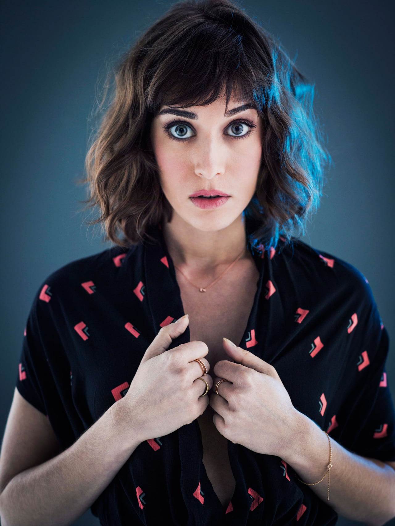 blue background, Lizzy Caplan, simple background, blue eyes, dark hair, 720P, brunette, women, actress, short hair, Phone HD Wallpaper