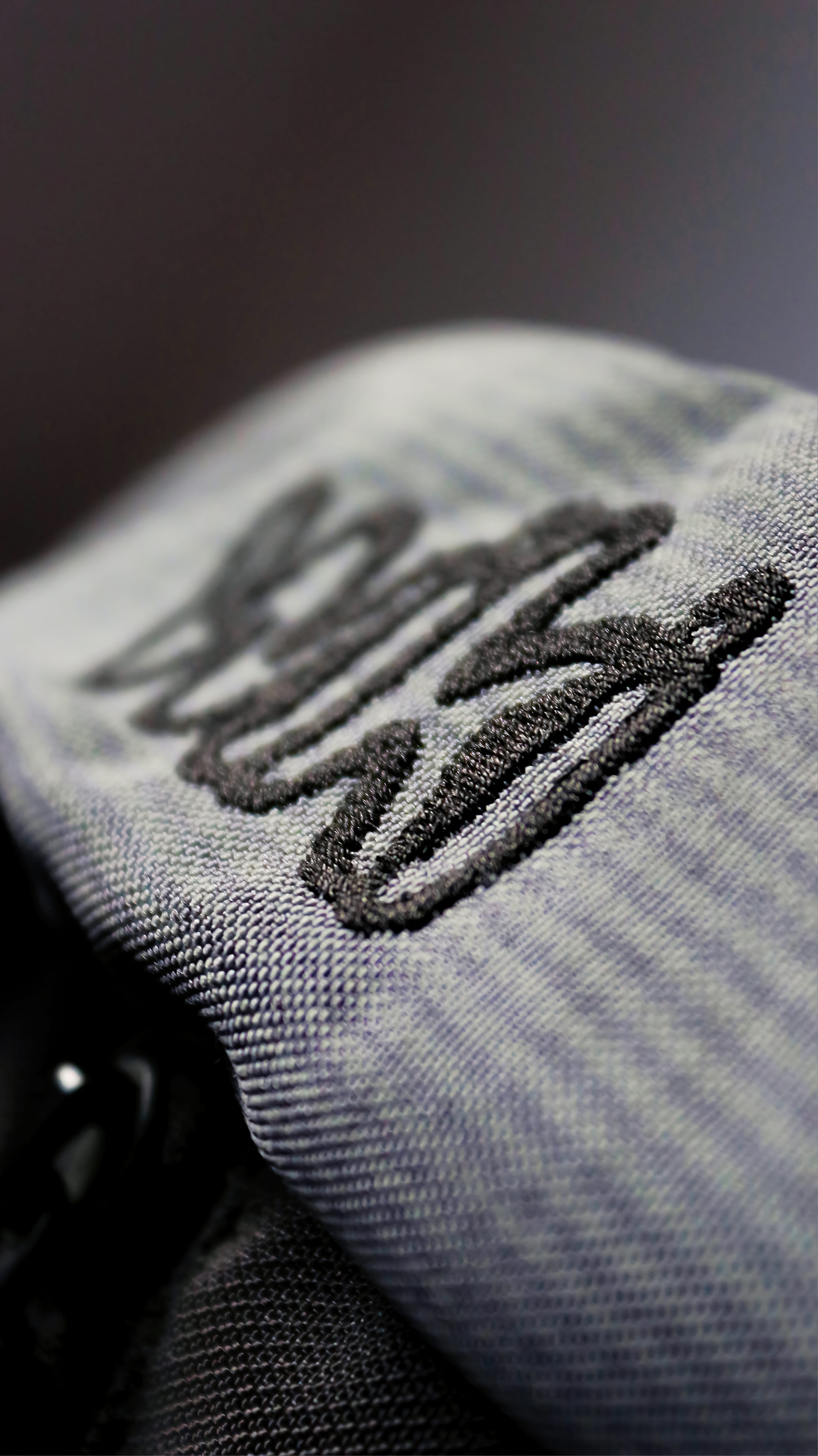 5K, casual clothing, full frame, brand, single object, clothing, close-up, focus on foreground, black, folded, textured, logo, wiki, warm clothing, selective focus, Phone HD Wallpaper