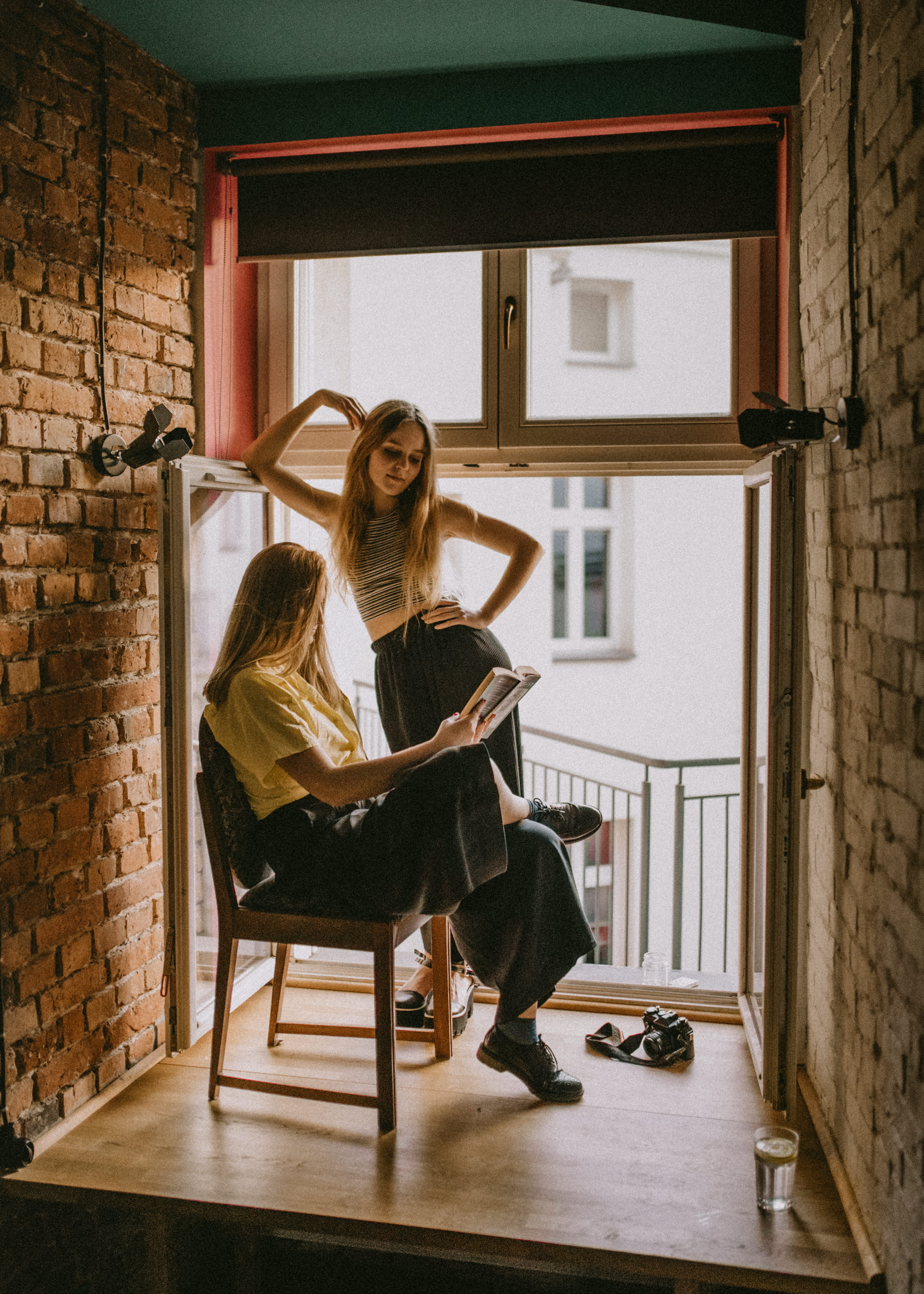 long hair, indoor, couple, real people, read, windowsill, room, standing, female, home interior, furniture, mode, fashion, indoors, hairstyle, lifestyles, Phone HD Wallpaper