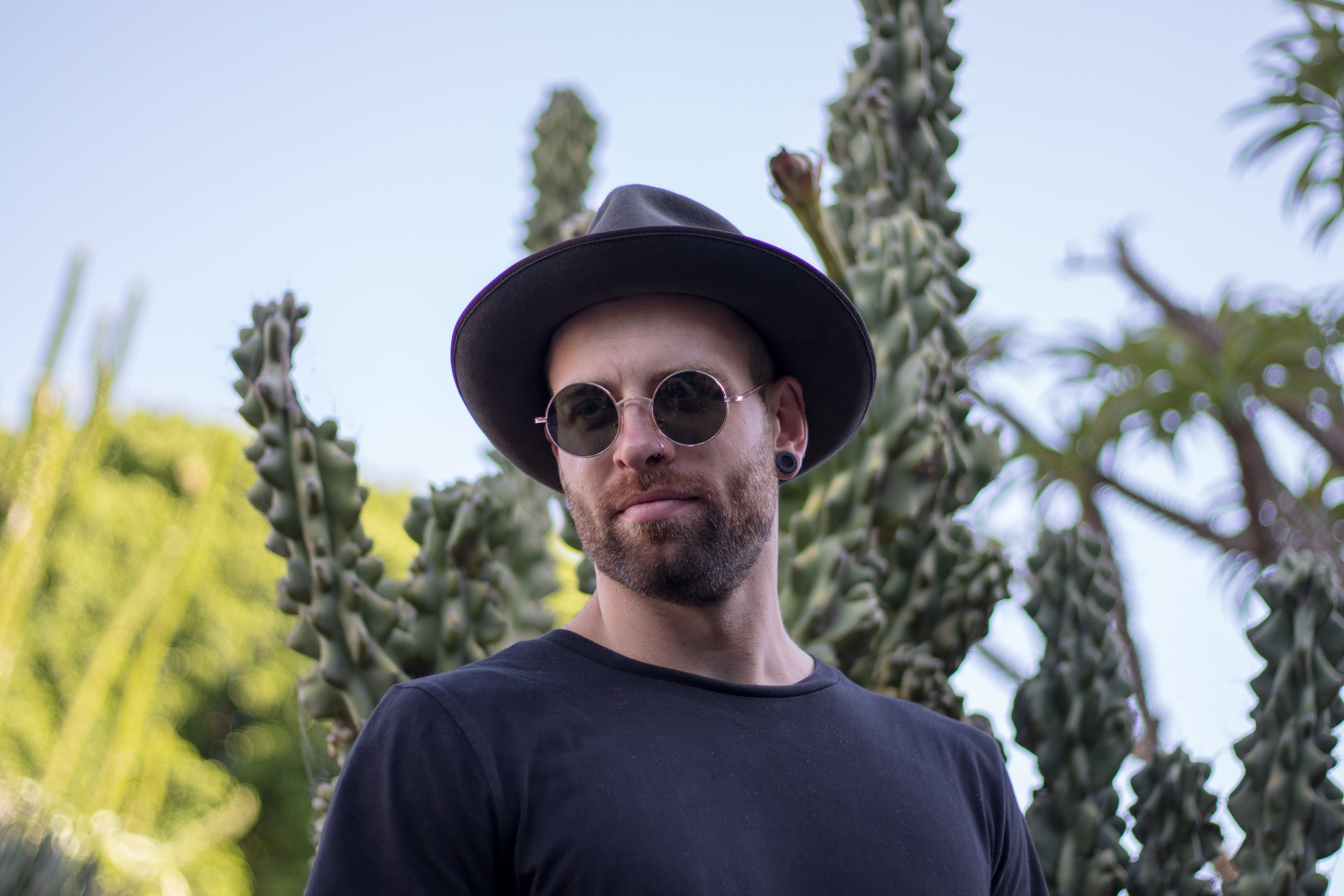character, real people, man, handsome, front view, glasses, one person, day, hat, casual clothing, cactus, leisure activity, fashion, tree, nature, expression, HD Wallpaper