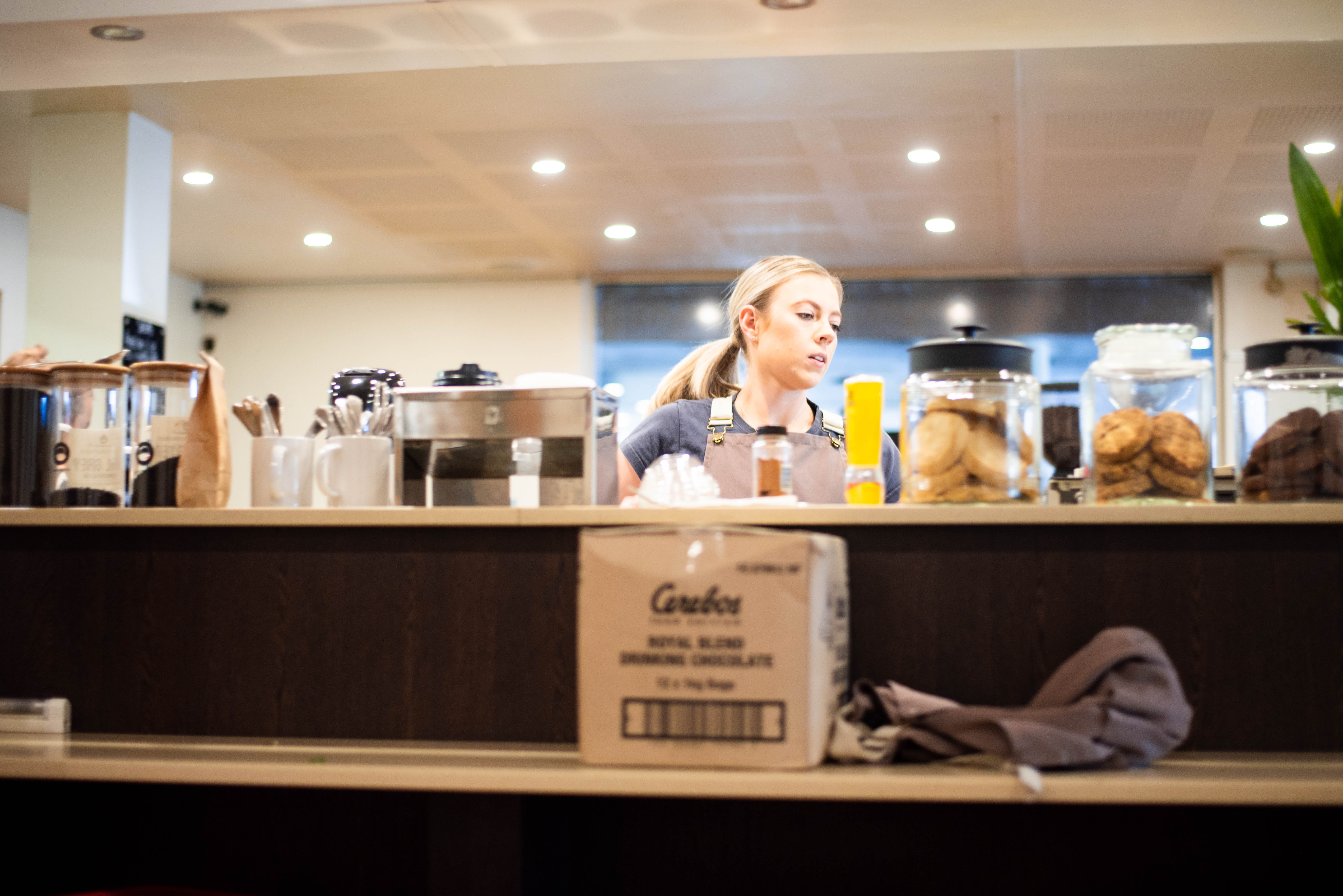 young adult, bar counter, counter, bench, illuminated, portrait, women, light, retail, cafe, hairstyle, work, jar, real people, happiness, biscuit, hair, HD Wallpaper