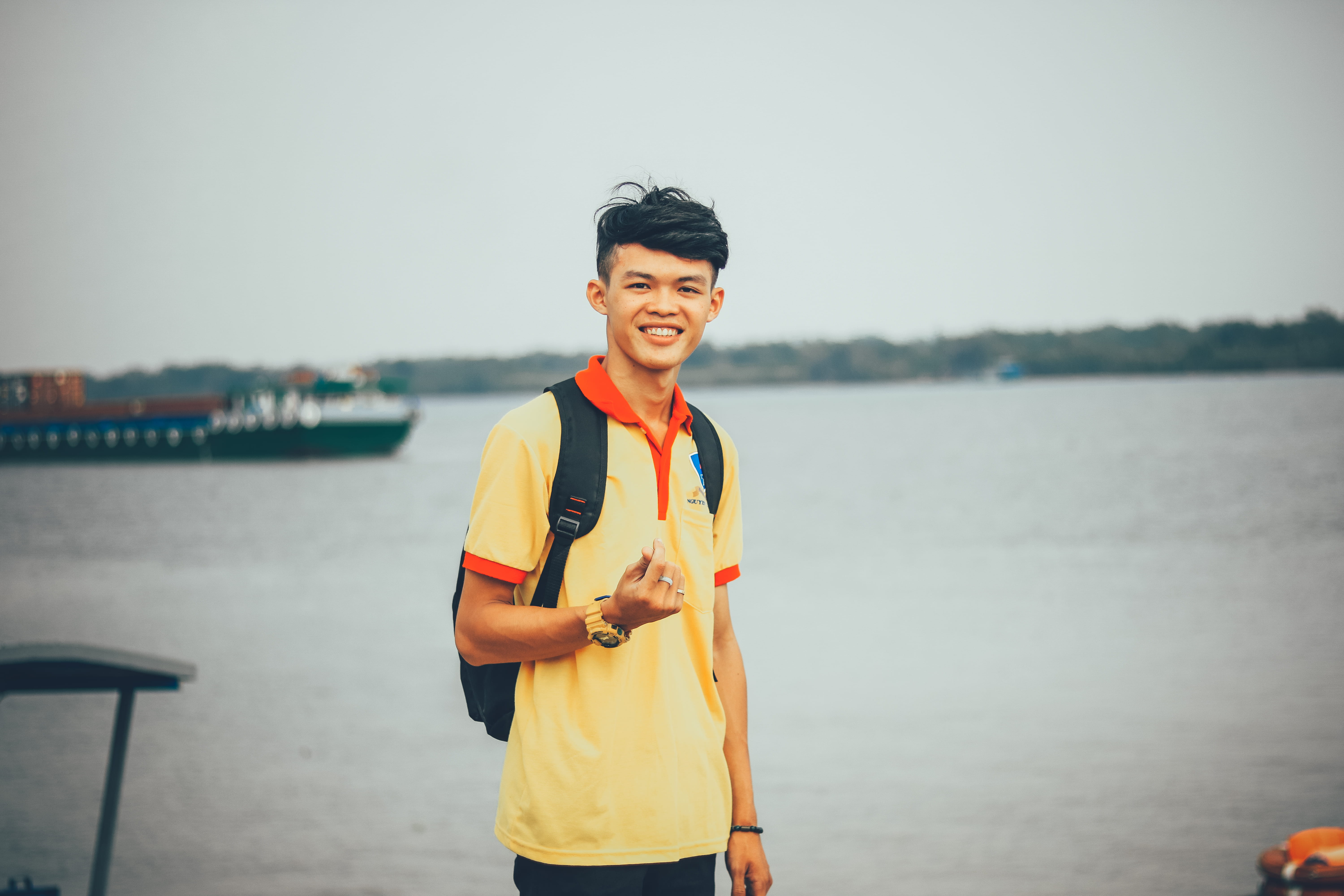 polo, focus on foreground, 5K, yellow, emotion, asian, wearing, child, nautical vessel, portrait, one person, packpack, happiness, body, orange, sea, men, HD Wallpaper