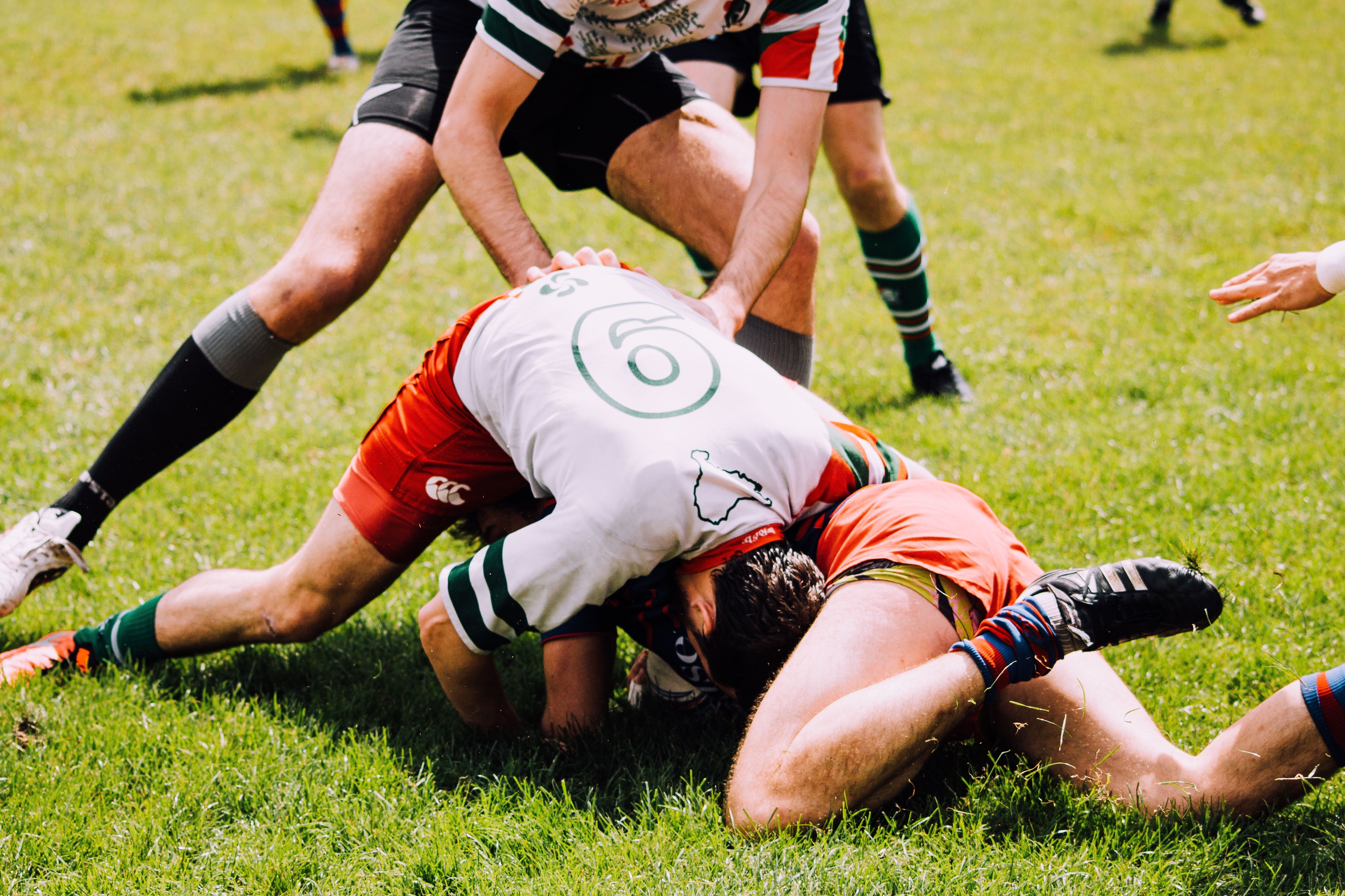 lying down, teamwork, clothing, sports uniform, sportsman, games, motion, green, playground, athletics, outdoors, people, adult, aggression, men, field, HD Wallpaper