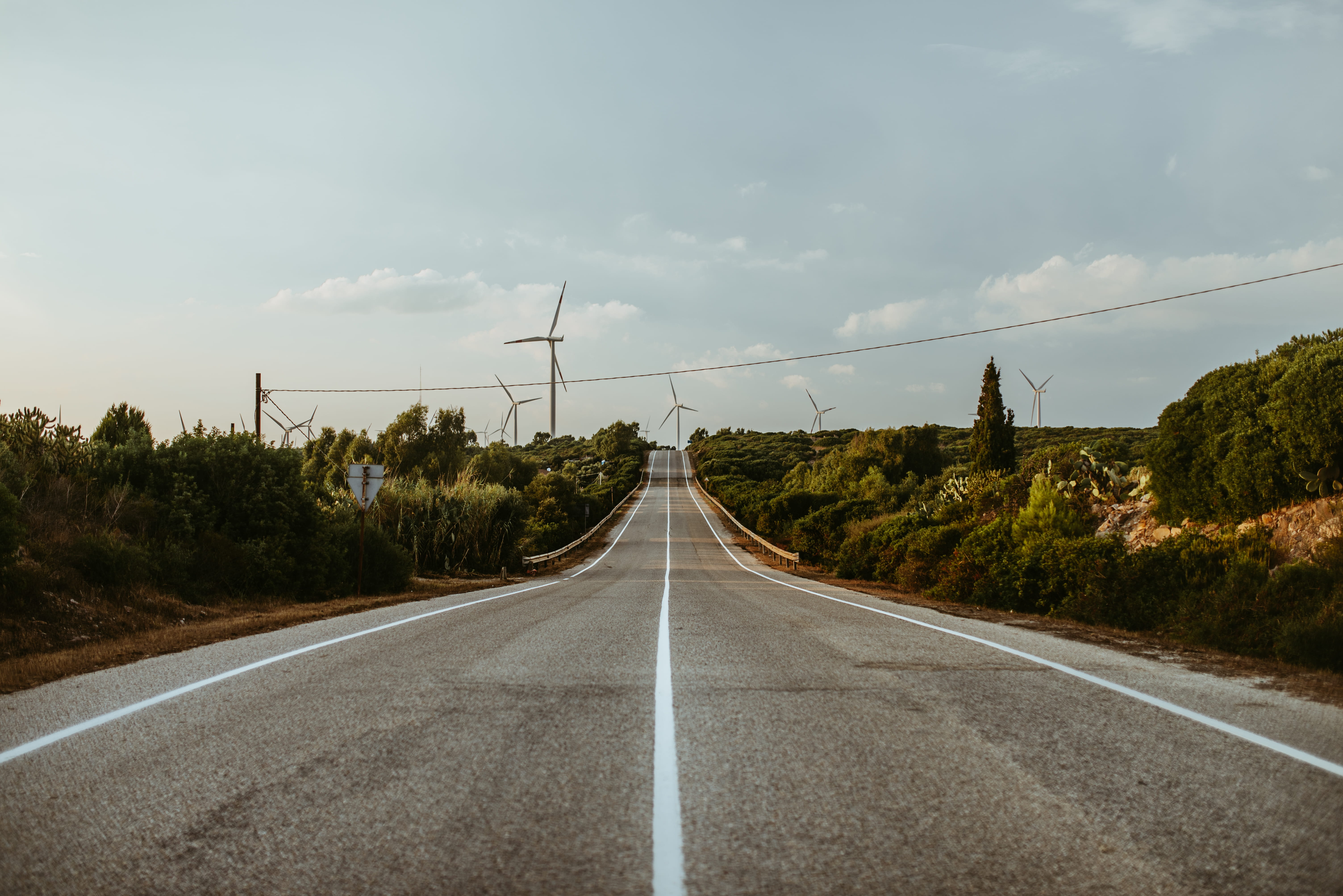 flora, dividing line, highway, street, sign, windmills, bush, dirt road, sky, transportation, no people, grey, road, tree, wind turbine, travel, powerline, HD Wallpaper